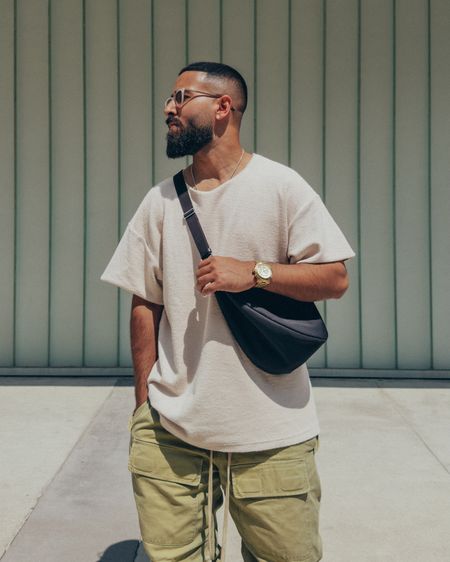 FEAR OF GOD Inside Out Shirt in ‘Sand’ (size M), Military Cargo pants in ‘Military Green’ (size M), Sock in ‘Cream’, and Boat Hi Boots in ‘Daino’ (size 42). THE ROW Slouchy Banana Bag in ‘Black’. FEAR OF GOD x BARTON PERREIRA glasses. A relaxed and elevated men’s look that is comfortable and easy to wear to lunch or a night out. An edgy army inspired look, featuring my go-to crossbody bag. 

#LTKmens #LTKstyletip