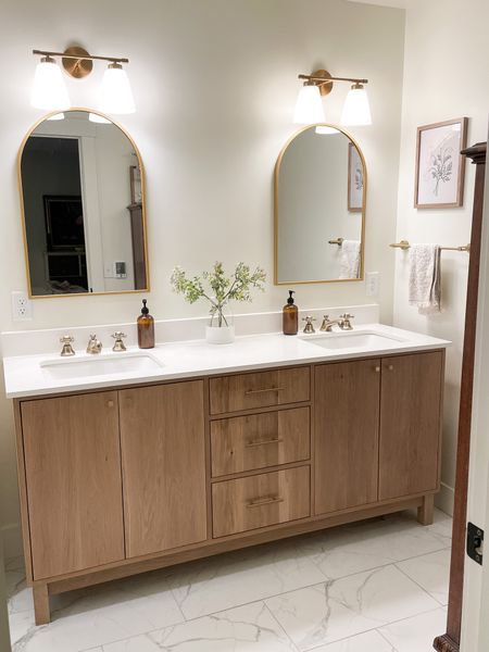I absolutely love our custom white oak vanity my husband built.  I picked gold finishes to bring warmth and glamour to our white quartz countertops.  

Master bathroom.  Double vanity.  

#LTKhome