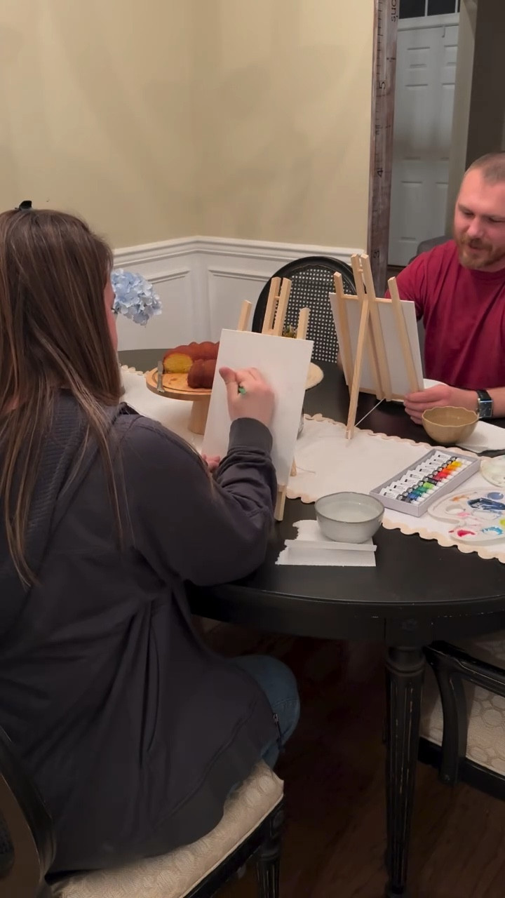 We tried the viral portrait painting date night, and I don’t think I’ve ever laughed this hard! 🤣 Poor Eric was stressing over how bad his was, while I just giggled at every deep breath and sigh he took. 🎨✨
We started doing at-home date nights four years ago because we could afford the date or the babysitter—but not both. Turns out, we’re total homebodies who love making fun memories at home anyway. This is part of my rooted in togetherness at home dates series. 

Try this with your husband? Here’s how to set it up: 🖌 Set up two easels facing each other (no peeking 👀) 🎨 Grab canvases, paint, brushes & water cups  🍸 Make fun drinks & treats (we had Harvey Wallbanger cake and cocktail!) 😂 Paint each other’s portraits & prepare to DIE laughing when you reveal them

Would you and your husband do this? Drop a 🎨 in the comments, and I’ll send you more fun at-home date night ideas! 💕

#datenightideas #athomedateideas #youngparents #budgetdateideas #dateyourhusband #dateyourspouse #momoflittleones #datenightathome