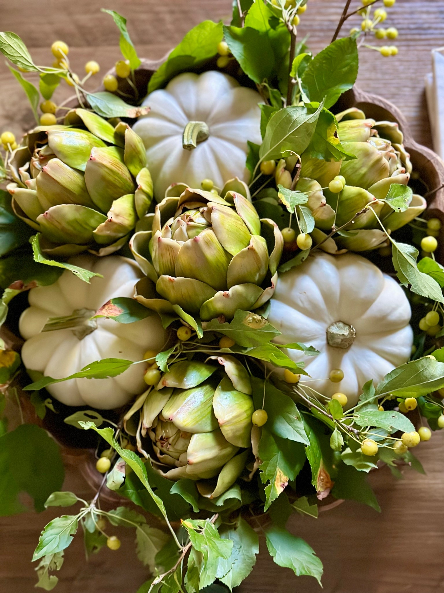 Fun fall centerpieces featuring the most realistic faux artichokes! This centerpiece was made with fresh branches and mini pumpkins - but I linked faux options for those interested! #falldecor #fallhomedecor #fallcoffeetable #fallcenterpiece 

#LTKStyleTip #LTKHome #LTKSeasonal