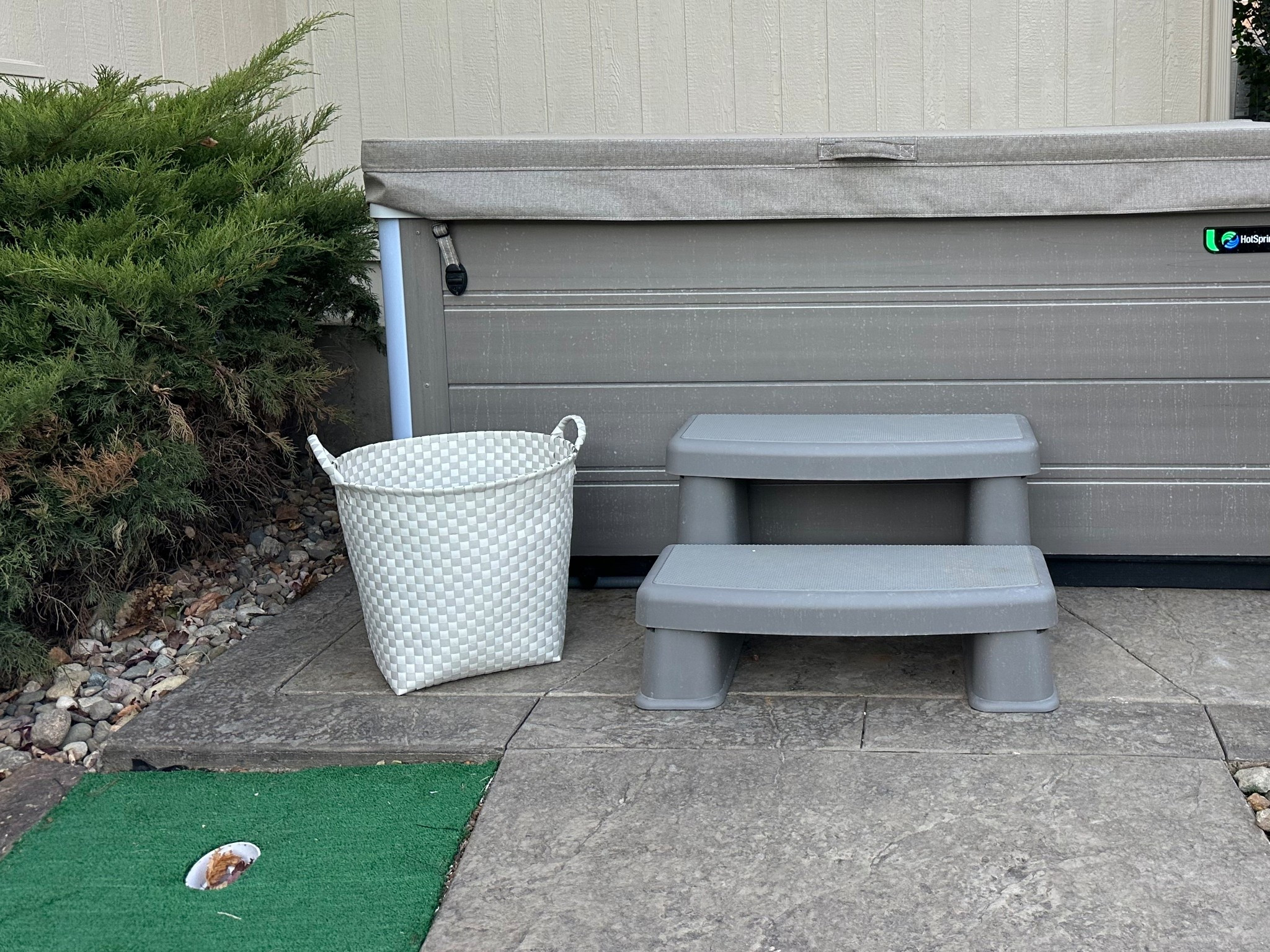 Basket next to hot tub for towels, phones, etc. Plastic-like and waterproof.