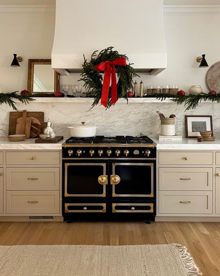 Kat Jamieson shares her kitchen decorated for Christmas. La Cornue, wreath, decor, home, marble, sconces, decorative accessories, festive, holiday. 

#LTKhome #LTKSeasonal #LTKHoliday