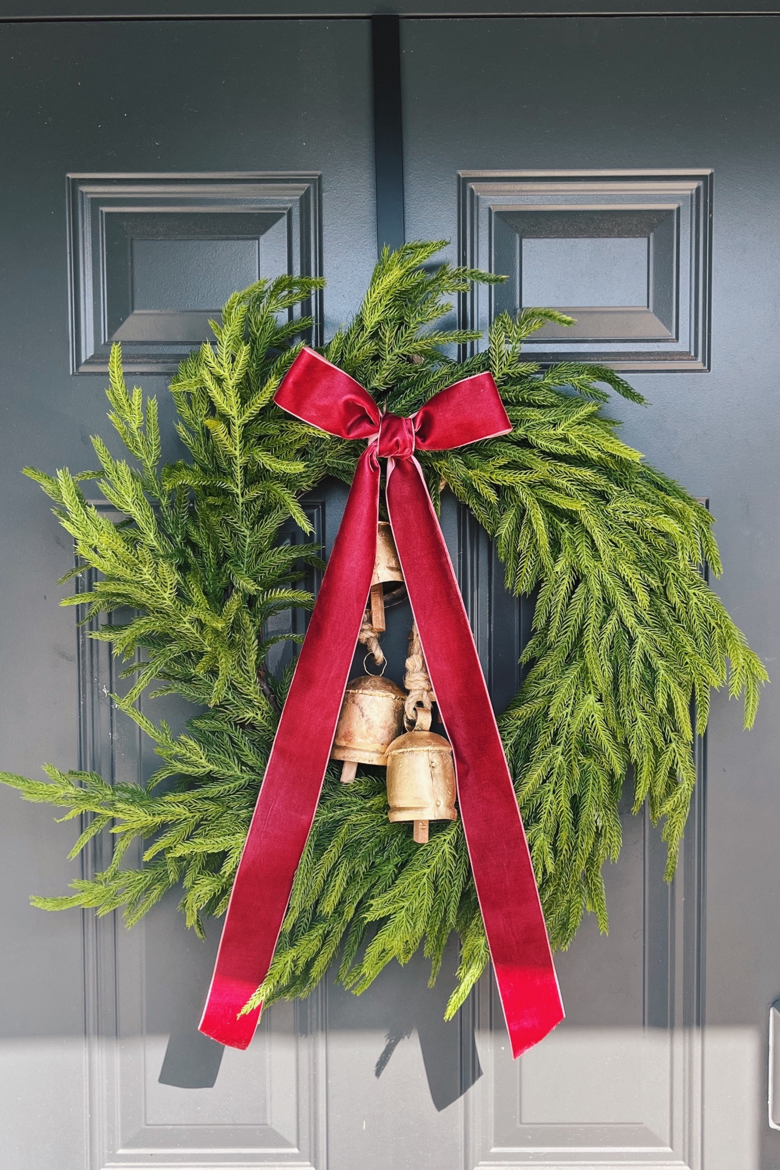 I decorated a wreath that I bought from Darby Creek. It’s Norfolk pine and looks so beautiful! I got vintage bells from Amazon. I finished it off with a wine colored velvet ribbon that I formed into a bow. It was a little DIY project that was super easy to make! 