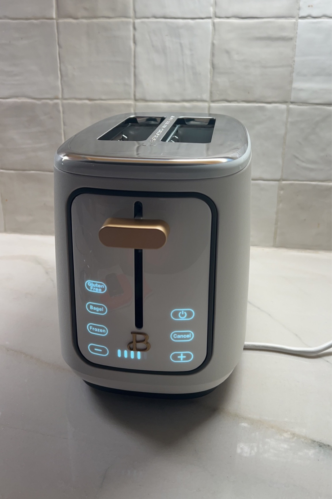 White and brass toaster 