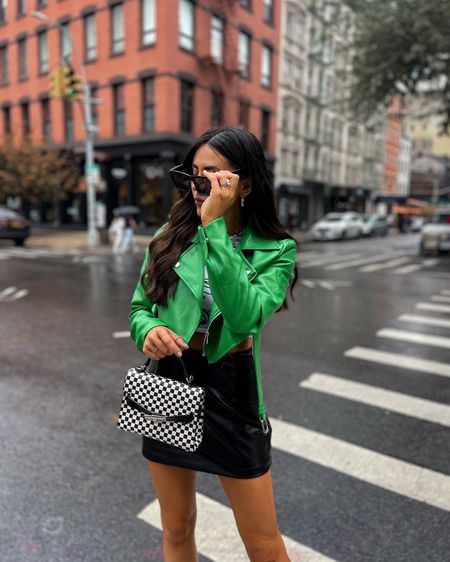 Edgy street style — green leather jacket (size 6), graphic crop top (size small), checkered handbag, green platform heels. Statement shoes + handbag 

#LTKshoecrush #LTKstyletip #LTKunder100