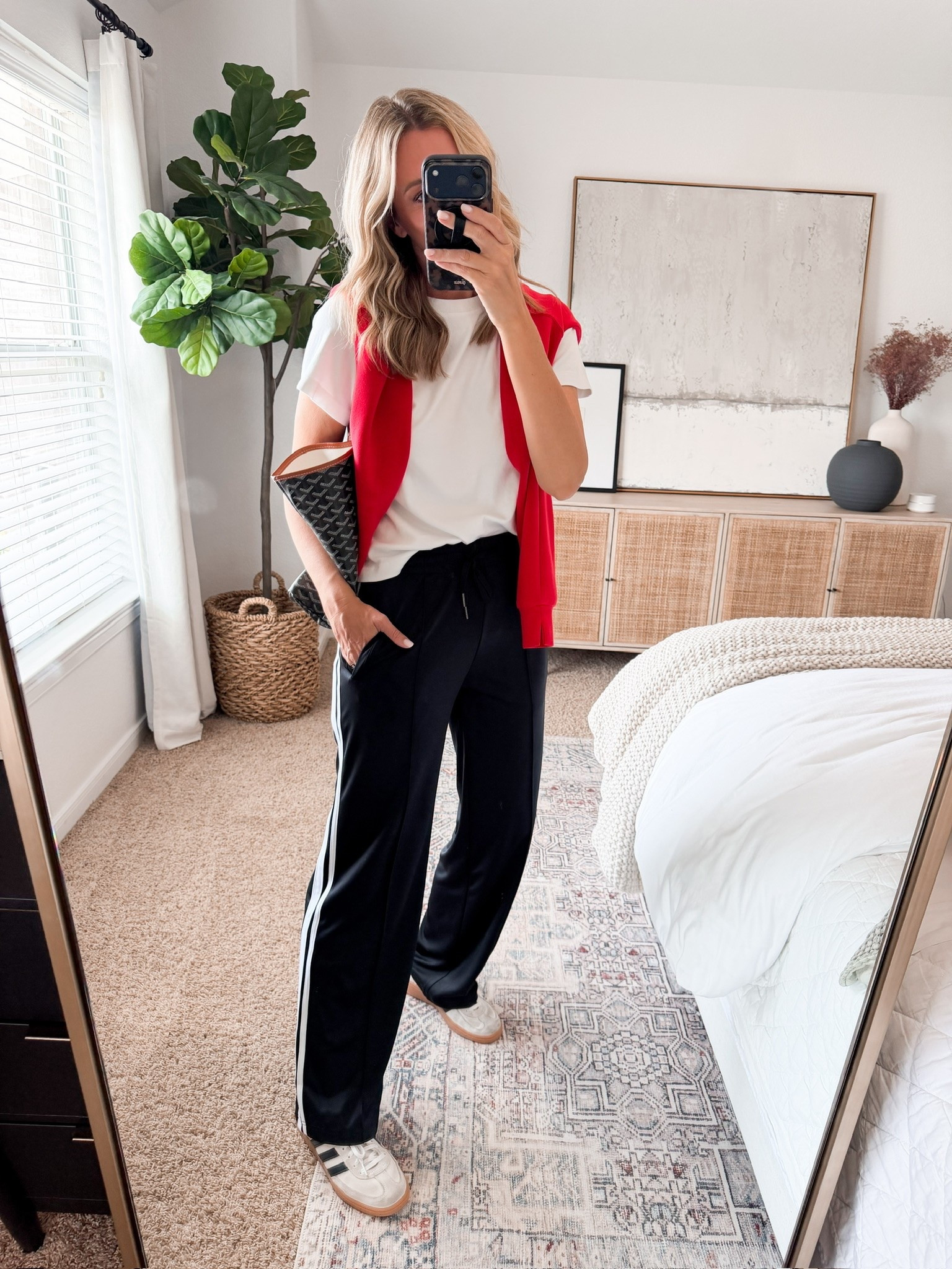 This is my kind of sporty fall outfit. The red sweater over the shoulders gives a simple white tee a fun pop of color, and the black wide leg track pants keep it comfortable enough for a full day out.

sporty fall outfit, red sweater, white tee outfit, black track pants, wide leg pants, casual fall outfit, fall athleisure, sneaker outfit, transitional fall style, everyday fall outfit, sporty casual style, HauteandHumid

#LTKootd #LTKSeasonal #LTKOver40