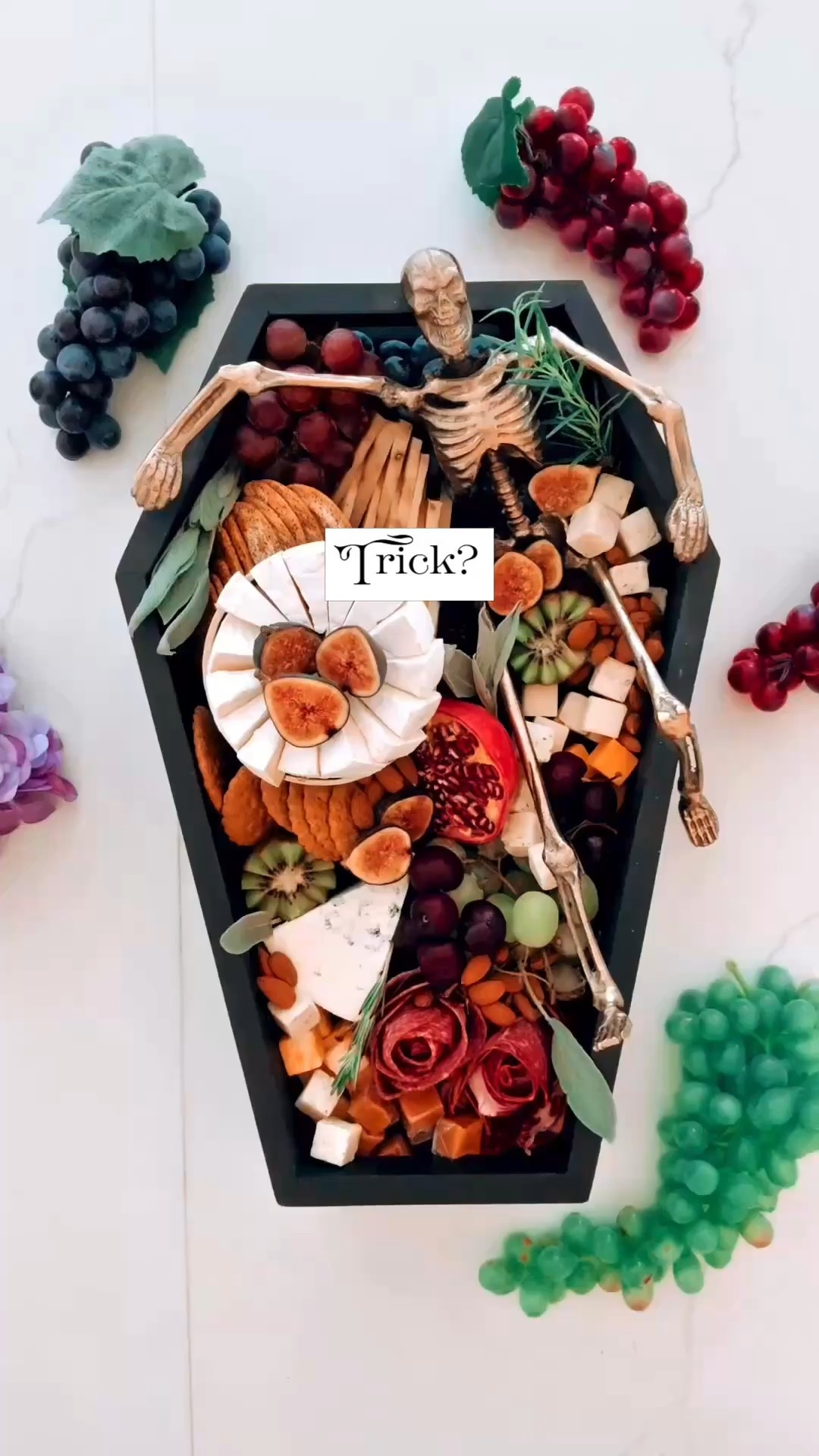 When Halloween snacks decide to dress up. 🕯️
This coffin-shaped board might be my favorite creation yet — complete with a golden skeleton lounging like it owns the place. On top, a tiny stand holding a brie wheel (because cheese deserves elevation), surrounded by figs, gorgonzola, charcuterie roses, pomegranate, berries, and a hint of sage and rosemary.
It’s spooky, but make it sophisticated — a ten-minute board that turns “trick or treat” into charcuterie couture. Serve it with a deep Cabernet and watch everyone pretend they’re at an elegant séance.
