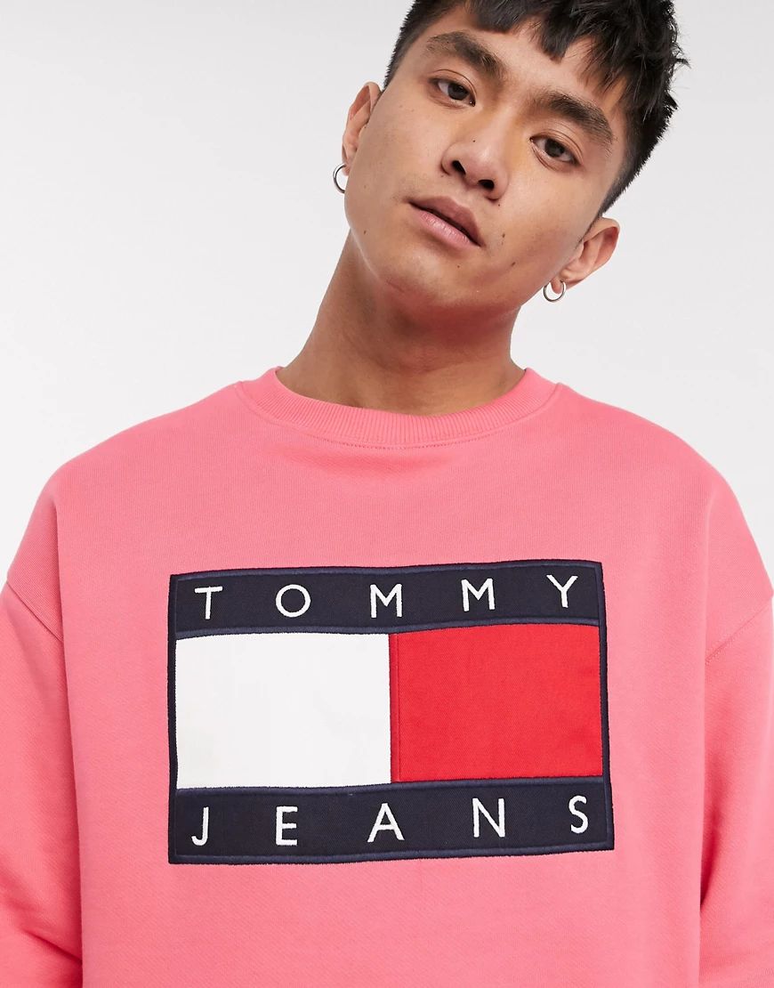 Tommy Jeans large flag logo crew neck sweatshirt comfort fit in washed pink | ASOS (Global)