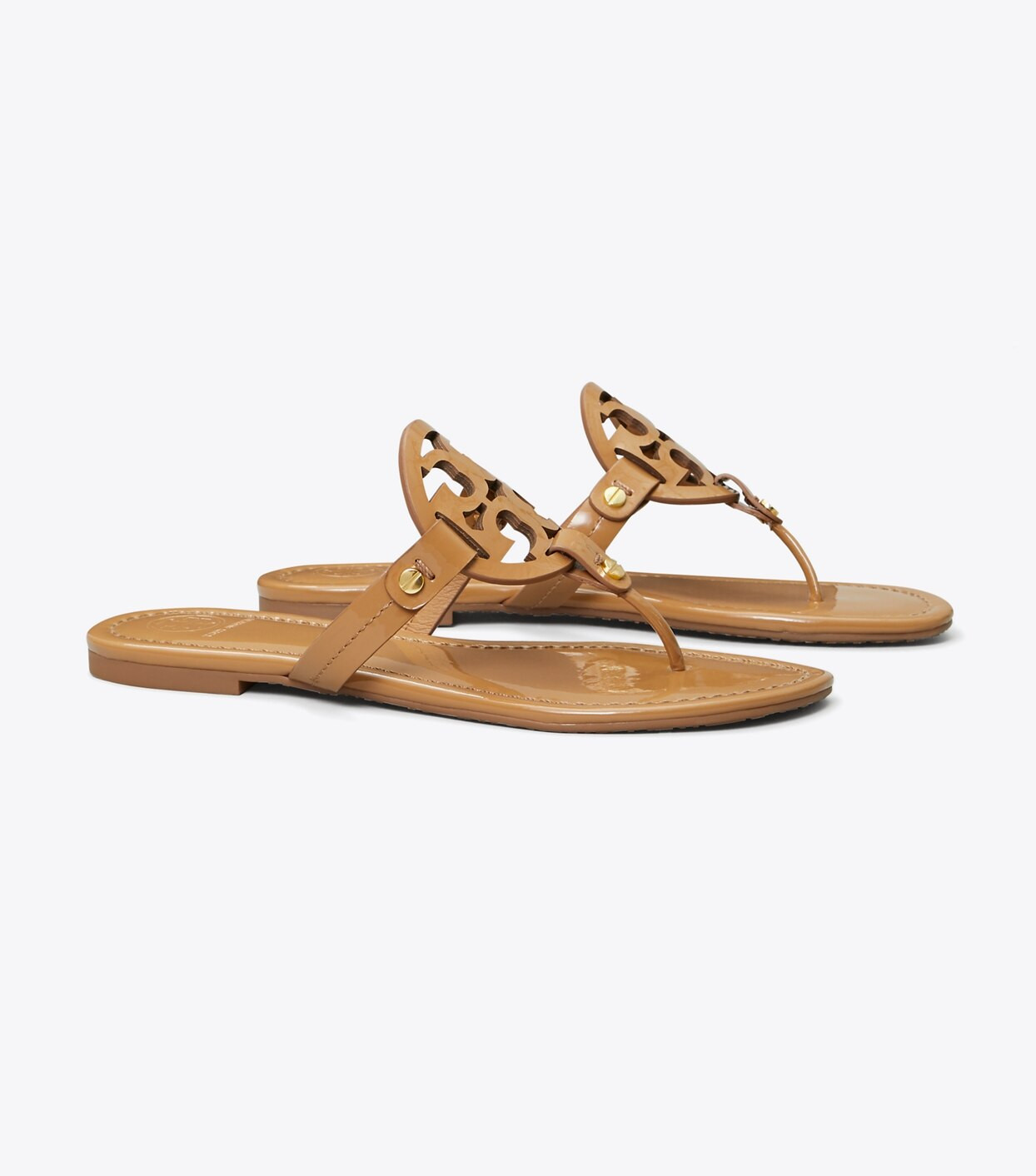 Beauty by design: the science of comfort. Our iconic Miller Sandal in patent leather features an ... | Tory Burch (US)