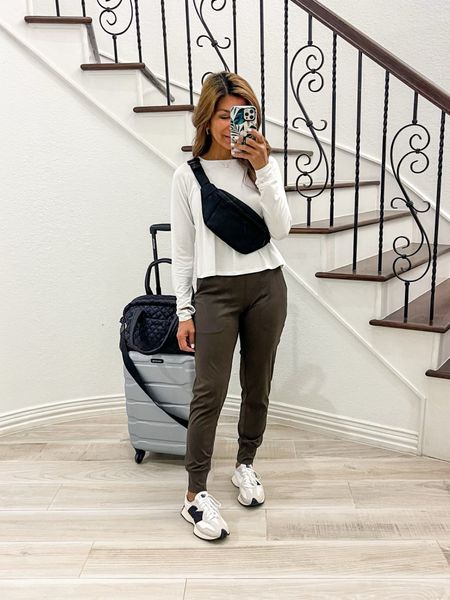 Airport outfit, Travel outfit.
Long sleeve top in small tts, white.
Active Pants in XS, color Olive Green, tons of colors, stretchy and comfy.
White sneakers fit tts.
Tank top underneath that you can layer I sized up to 6.
Belt bag, personal carry-on bag, and fav luggage are linked. I’m also linking a more affordable option of the personal bag that I also own. 
Luggage color is silver and the image online looks darker but it’s a nice silver color in person. I just bought the 3-piece set. It’s the best and high quality. 
Amazon find, spring vibes, fashion over 40, petite style, comfy outfit, casual outfit.

#LTKtravel #LTKfindsunder50 #LTKover40