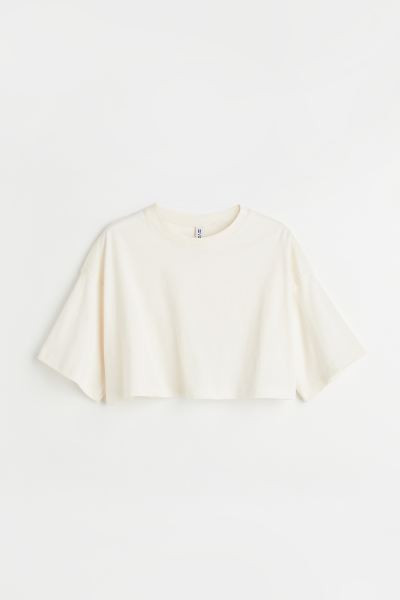 Boxy-style, cropped T-shirt in soft jersey with a round, rib-trimmed neckline, dropped shoulders ... | H&M (UK, MY, IN, SG, PH, TW, HK)