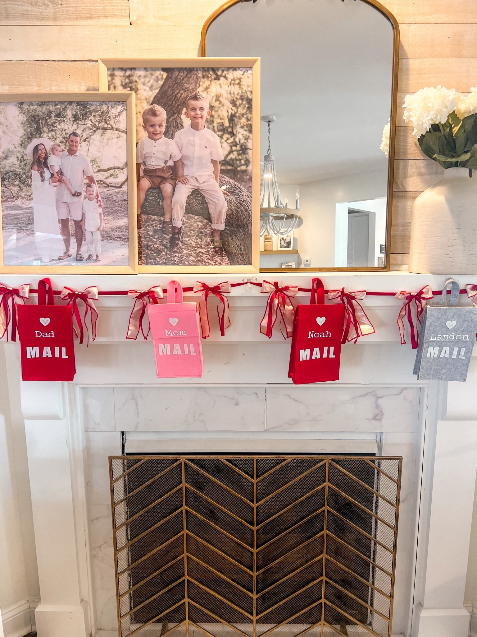 Personalized valentines day mailboxes 
Red and pink ribbon bow garland 
Gold antique mirror 
Gold chevron fireplace cover 