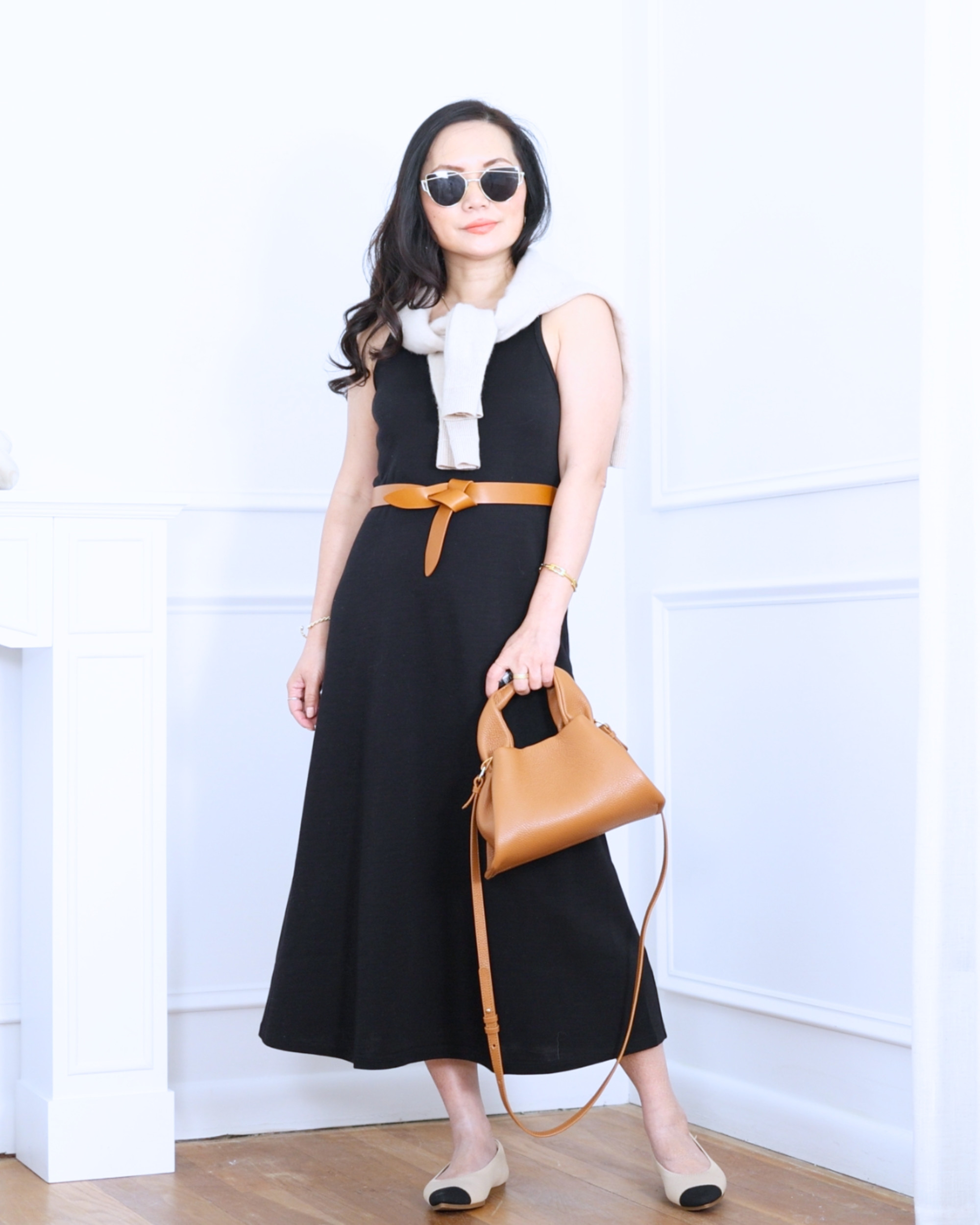 Black long dress from Unbound Merino styled with a Quince sweater draped over the shoulders, finished with a belt, bag, and pointed-toe ballet flats from Vivaia — classic, polished, and effortlessly put together. I'm 5'2, wearing size S. 

 #LTKootd #LTKOver40 #LTKPetite