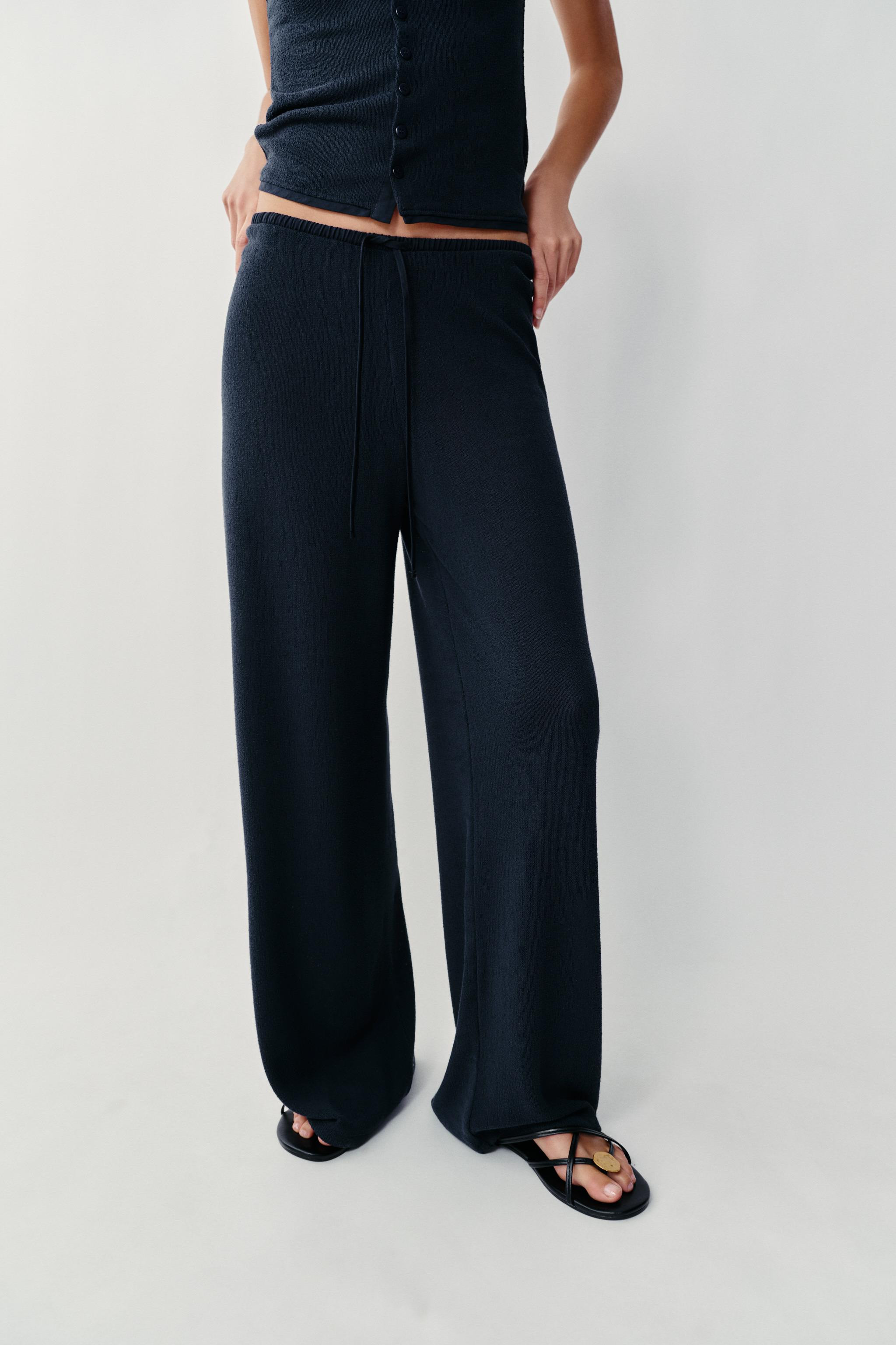 Pants made of a viscose blend yarn. Mid rise with adjustable drawstring waistband. Wide leg. | Zara US