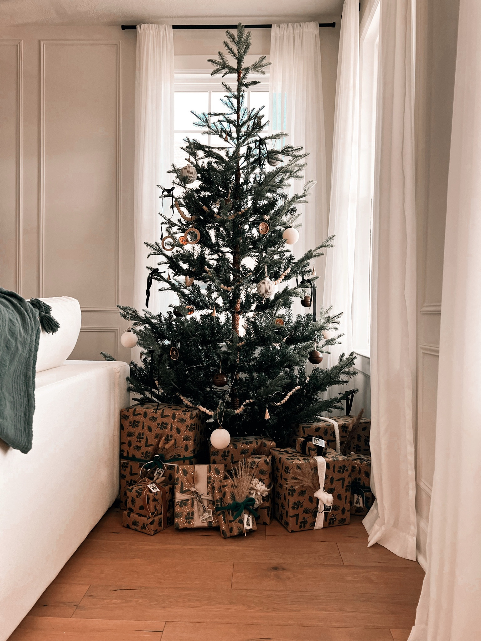 Our neutral Christmas tree + neutral gift wrapping 🌲
.
Just add ornaments, wooden beads, black velvet ribbon bows, and dried oranges to complete the look ✨


#LTKHome #LTKHoliday #LTKSeasonal