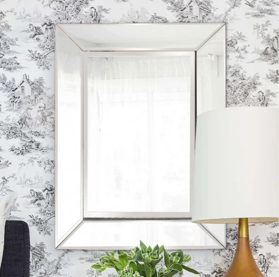 Whether you want to grab a glimpse of your reflection as you get ready in the bathroom, or you’re just looking to spruce up a blank space on your wall, this versatile vanity mirror is here to help! Crafted from beveled glass, this rectangular piece is framed by mirrored panels that are slightly angled to scatter light throughout your space, instantly opening up any room. Measuring 24'' H x 18'' W x 1'' D overall, this design can be hung vertically or horizontally as soon as it arrives thanks to included installation hooks.

#LTKsalealert #LTKstyletip #LTKhome
