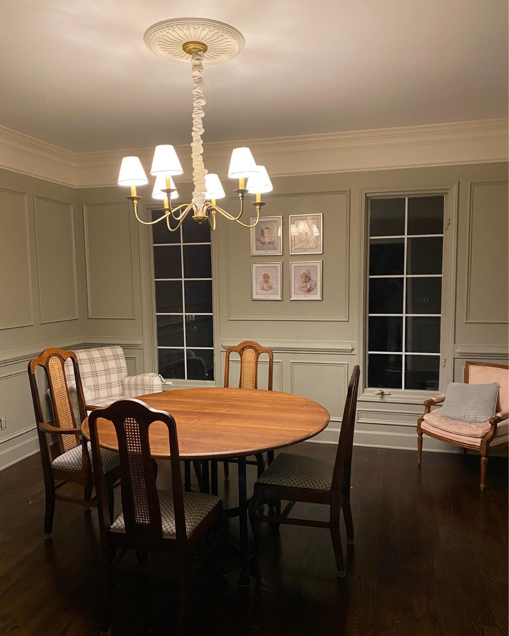 The evolution of a room ✨ Wall color: French Gray by Farrow and Ball
Trim: School House White by Farrow & Ball 
Both color matched to @benjaminmoore paint. 
Chandelier is a steal from wayfair, table and chairs are thrifted, plaid chair also from wayfair, and framed pictures from @framebridge. I’ll link everything on my liketoknowit page (link in bio) 

Still some finishing touches I plan to do: hang curtains, thrift for artwork, a vase of flowers and a side table, etc etc. It’s so fun bringing all the little details together. I was definitely nervous to do a green room, but out of all the paints I tested, nothing really got me excited or made me feel anything, until I tested this one 🥰 It looks different at all times of the day which is so fun, the room is definitely warm & inviting and the green is not overpowering just as I had hoped!  #frenchgrayfarrowandball #frenchgray #farrowandball #diningroommakeover #diywainscoting #diyroommakeover #cottagestyle #frenchcountrydiningroom #vintageinspired #cozydiningroom 