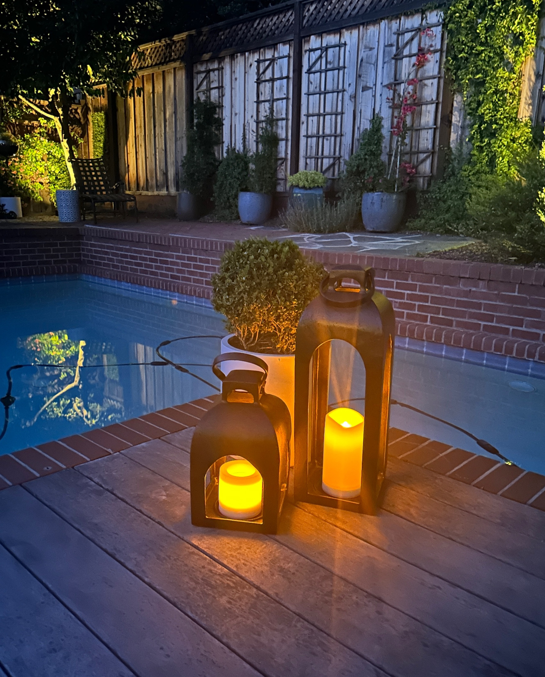 These lanterns from Target and solar powered lights are making our yard look really cute and feel like a resort.  The lanterns are tough and will last and look so nice. I have one on my front patio too. 

The solar outdoor candles are the best!! Never need to replace batteries. They do get enough sun to power them just sitting in the lanterns. I use these all over the yard .

#LTKSeasonal