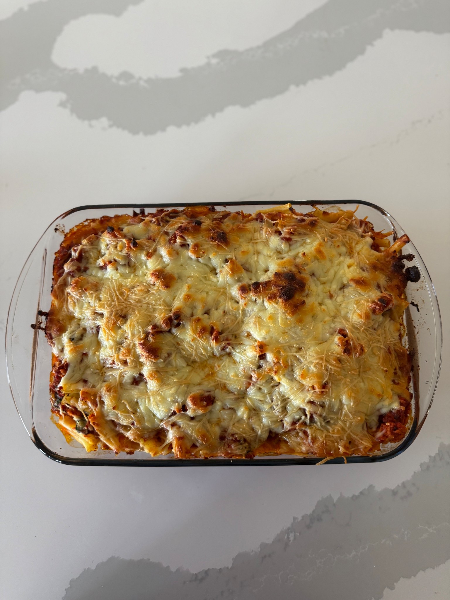 I suck at taking aesthetic pictures of food lol but I promised this baked ziti is SO good! It’s one of the very few things all 6 of my kids will eat lol! Ingredients and recipe below: 

 Ingredients:
1 lb box ziti
1 Ib 99/1 lean ground turkey
1/2 small yellow onion (100 g) diced
2 24 oz jars marinara sauce
1 tsp each: dried oregano, basil, garlic powder
1/2 tsp ground thyme
pinch red pepper flakes - optional
3 cups fresh spinach (64 g) roughly chopped
5 oz mozzarella cheese (140 g) ~ 1 2/3 cups
1 cup 2% low fat cottage cheese
1 oz parmesan cheese (28 g) ~1/3 cup fresh grated
fresh basil or parsley - optional, to garnish
Instructions:
1. Preheat oven to 400 F and lightly grease a 9x13 glass
baking dish.
2. Bring a large pot of salted water to a boil. Cook pasta according to box instructions until al dente. Drain and rinse with cold water to stop cooking.
3. Meanwhile, set a large deep skillet on medium high.
Spray with oil, add turkey and onion and cook, breaking turkey apart into small pieces (~5 min). Season with salt and pepper (I do 1 tsp salt, 1/2 tsp pepper).
4. Reduce heat to medium low and add marinara, dried oregano, basıl, garlic powder, thyme and red pepper tlakes.
Gently simmer 10-15 minutes. Add spinach during the last
2-3 minutes.
5. In the baking dish, layer 1/2 pasta, 1/2 sauce, cottage cheese and 1/2 mozzarella. Repeat with remaining pasta and sauce, then top with mozzarella and parmesan. Bake for 20 minutes. Garnish with basil or parsley and enjoy!