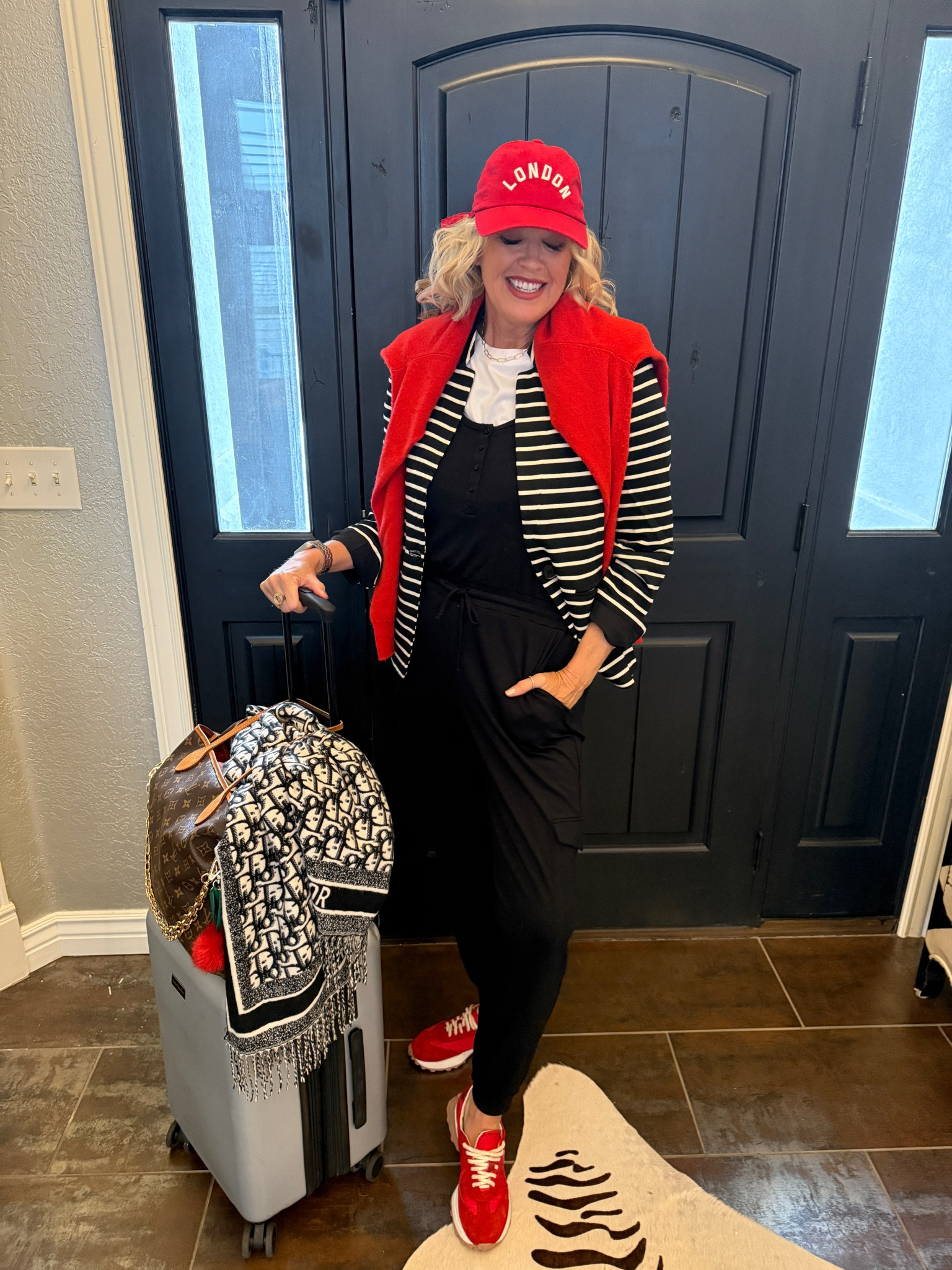 Travel outfit style
Gibsonlook 

Save 10% with code DARCY10

Gibsonlook striped blazer fits tts I am in a med 
Soft and jersey feel 

Gibsonlook black jumpsuit that ties at waist and has pockets  
Tts in a small 

White tee shirt bodysuit by spanx tts in a med

Red London baseball cap 
Anthro 

Red handmade sneakers Madison Masion  tts

Red Pura cashmere sweater tts

Vera Bradley luggage 

Dior scarf 

Louis Vuitton never fun large

Bag charms anthropology 

Gold hoops Kendra Scott
Cross necklace Kendra Scott 
Paper clip chain cart gold jewelry (linked costume jewelry look alike bauble bar) 

Apple Watch Michelle watch band


#LTKWorkwear #LTKTravel #LTKStyleTip