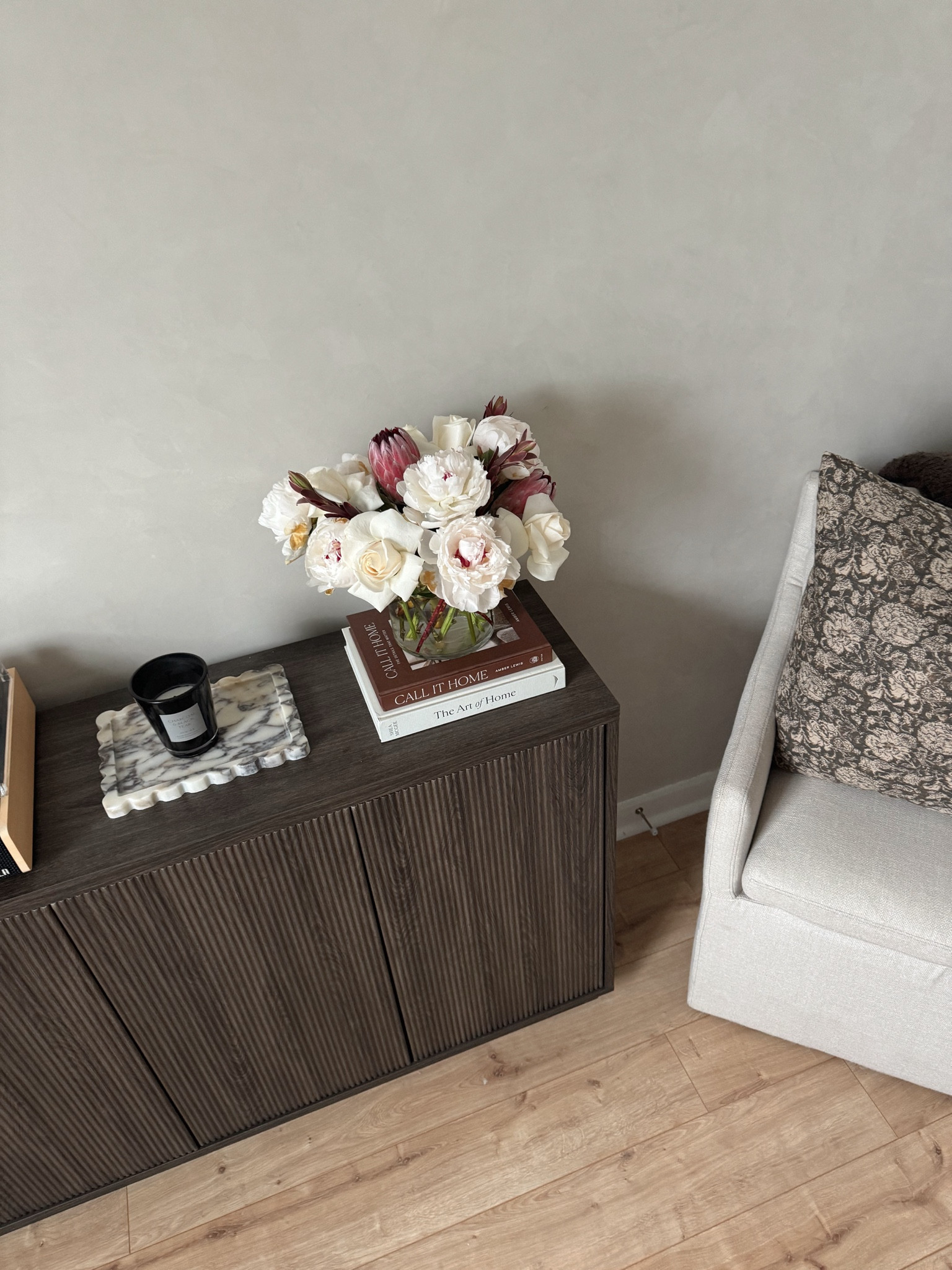 Home Office is coming together! I am adding in some more moody and dark neutral tones, especially for fall. This credenza is extremely affordable and looks so upscale. Linking my favorite accent pillow from Target and some marble trays, black candle, brown coffee table books and brown boucle blanket  
