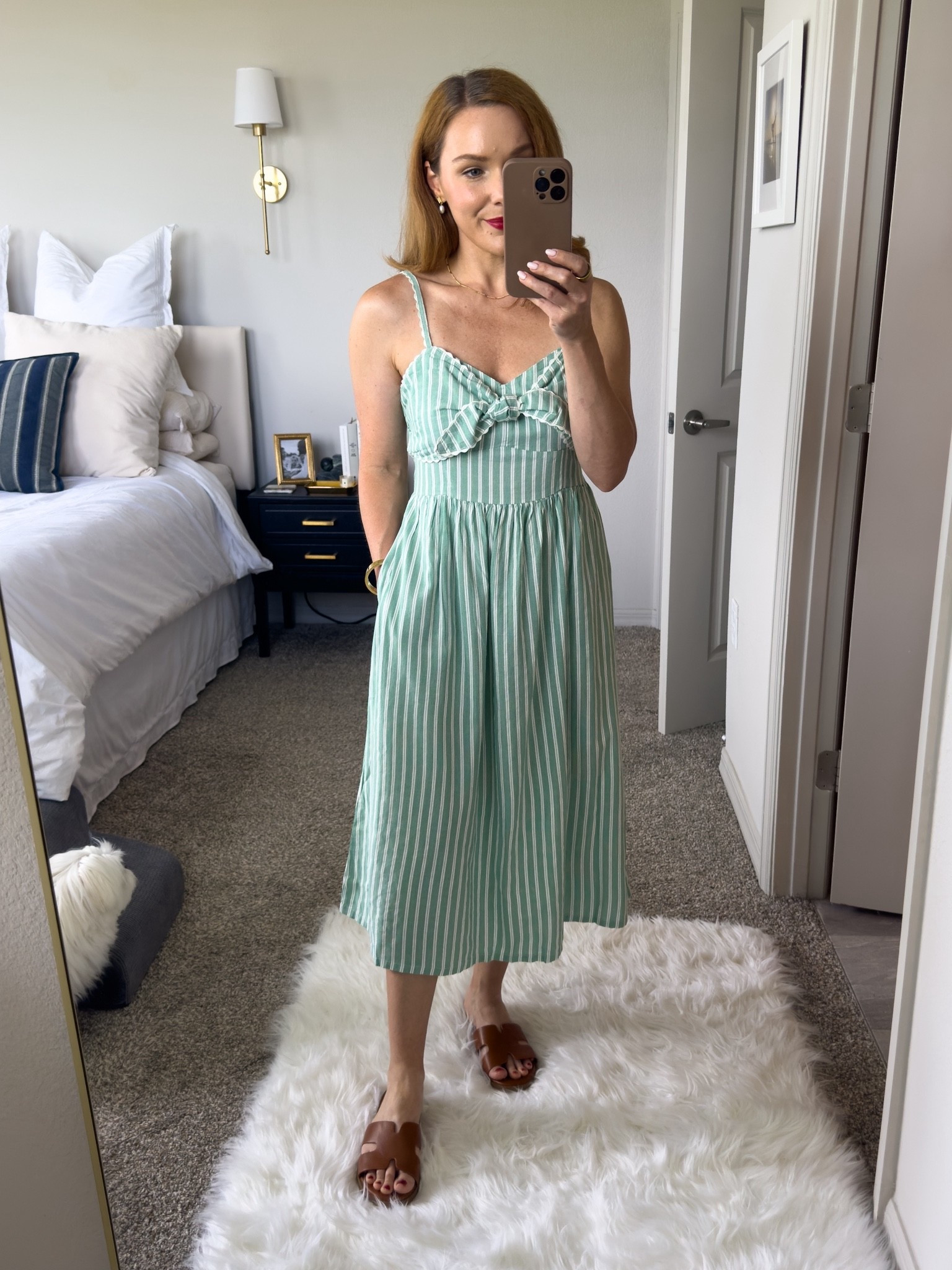 Cute seersucker midi length sundress with tie detail on top that’s currently on sale for 40% off. The straps are adjustable and it’s available in petite sizes, I’m wearing xs petite. The elastic smocking on the back makes for an easy fit. It has pockets and offered in three other colors. #oldnavy #sundress #summerstyle 

#LTKFindsUnder50 #LTKPetite #LTKSaleAlert