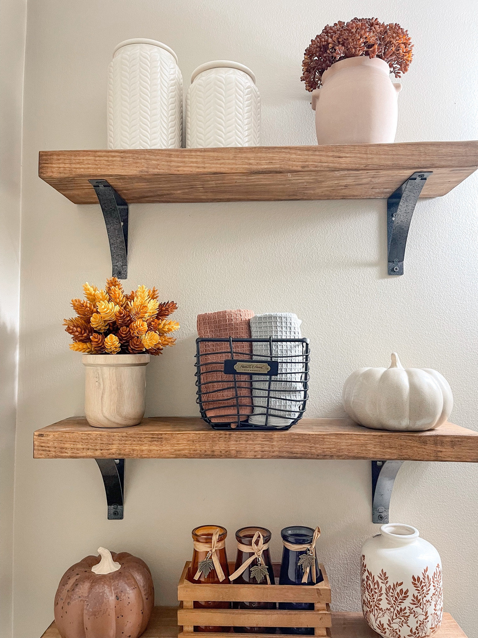 Fall shelf styling in my powder room I used canisters, floral arrangements and pumpkins  #falldecor #targetdecor #bathroomdecor 

#LTKSeasonal #LTKhome #LTKsalealert