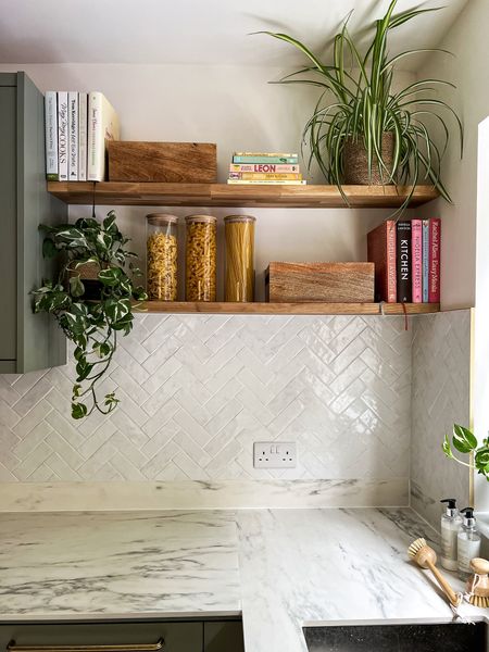 Kitchen shelves storage, pantry storage for pasta jars, spice racks used as tea towel storage and cook books for easy access to your favourite recipes with decorative home accessories and straw plant pots

#LTKhome #LTKeurope #LTKSeasonal