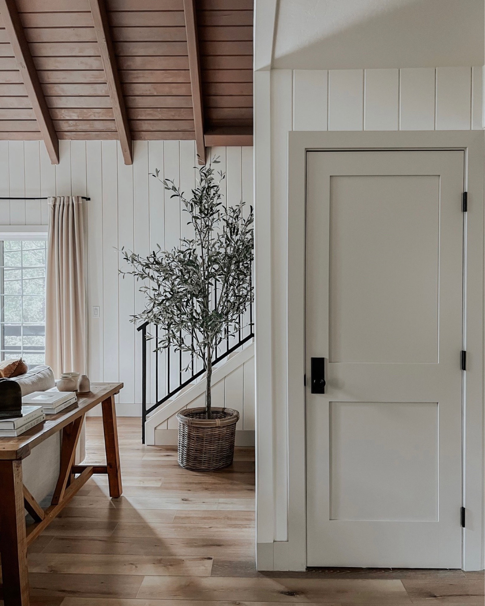 Here’s a look at the 9’ olive tree in our lake house! Comes in other smaller sizes too. Walls are Benjamin Moore White Dove and door is Benjamin Moore Revere Pewter 

#LTKSeasonal #LTKsalealert #LTKhome