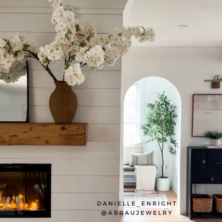 I love dramatic stems and neutral decor. I’d say my home is a mix of organic rustic modern 💐 

🏷️ home decor , distressed mantel , 
Modern farmhouse style , picture light , electric fireplace , wood bench , artificial tree , olive tree , storage baskets , wall art , cherry blossom stems , spring floral arrangement , mantel arched mirror , rustic vase , cozy home , dining room decor

#LTKfindsunder100 #LTKhome