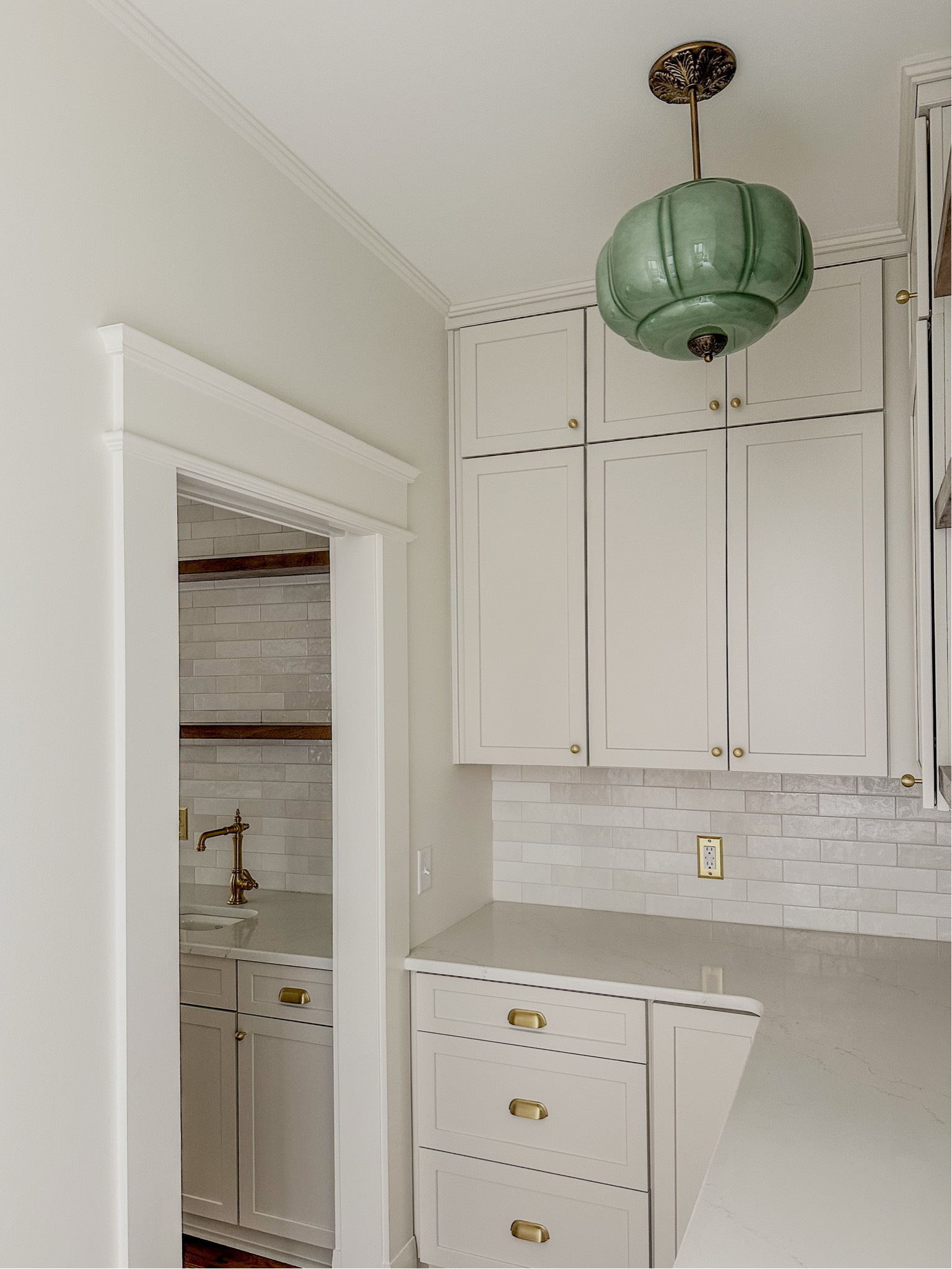 Aesthetic butler’s pantry with vintage-inspired lighting, traditional subway tile backsplash, brass hardware, and a prep sink with a brass Kohler faucet. 😍 #bedrosians #anthropologie #butlerspantry #anthroliving #kohler

#LTKCyberWeek #LTKHome