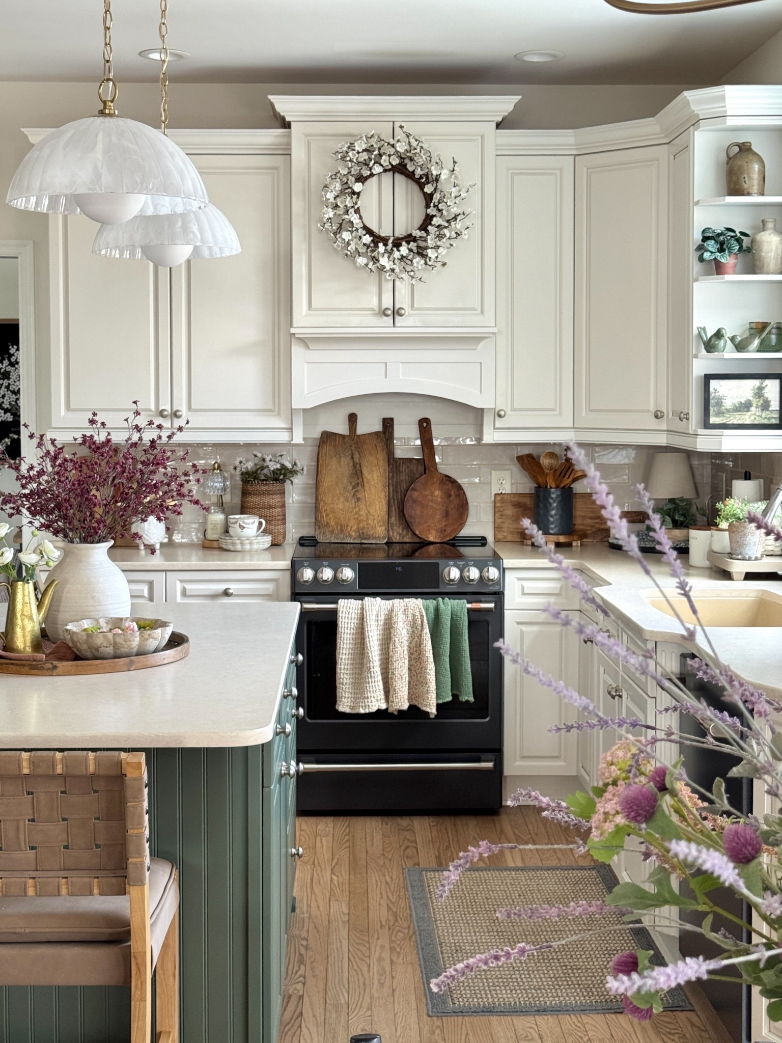 Kitchen decor - spring edition  My new swirled glass pendant lights with natural brass accents and chain are gorgeous! 24” Plum Blossom Wreath, dark pink cherry blossom stems, rattan wall basket set of two, distressed cutting boards set of three, scalloped white dessert plates, pretty pheasant patterned mug, waffle towels, matte black utensil holders set of two, wooden utensils. 