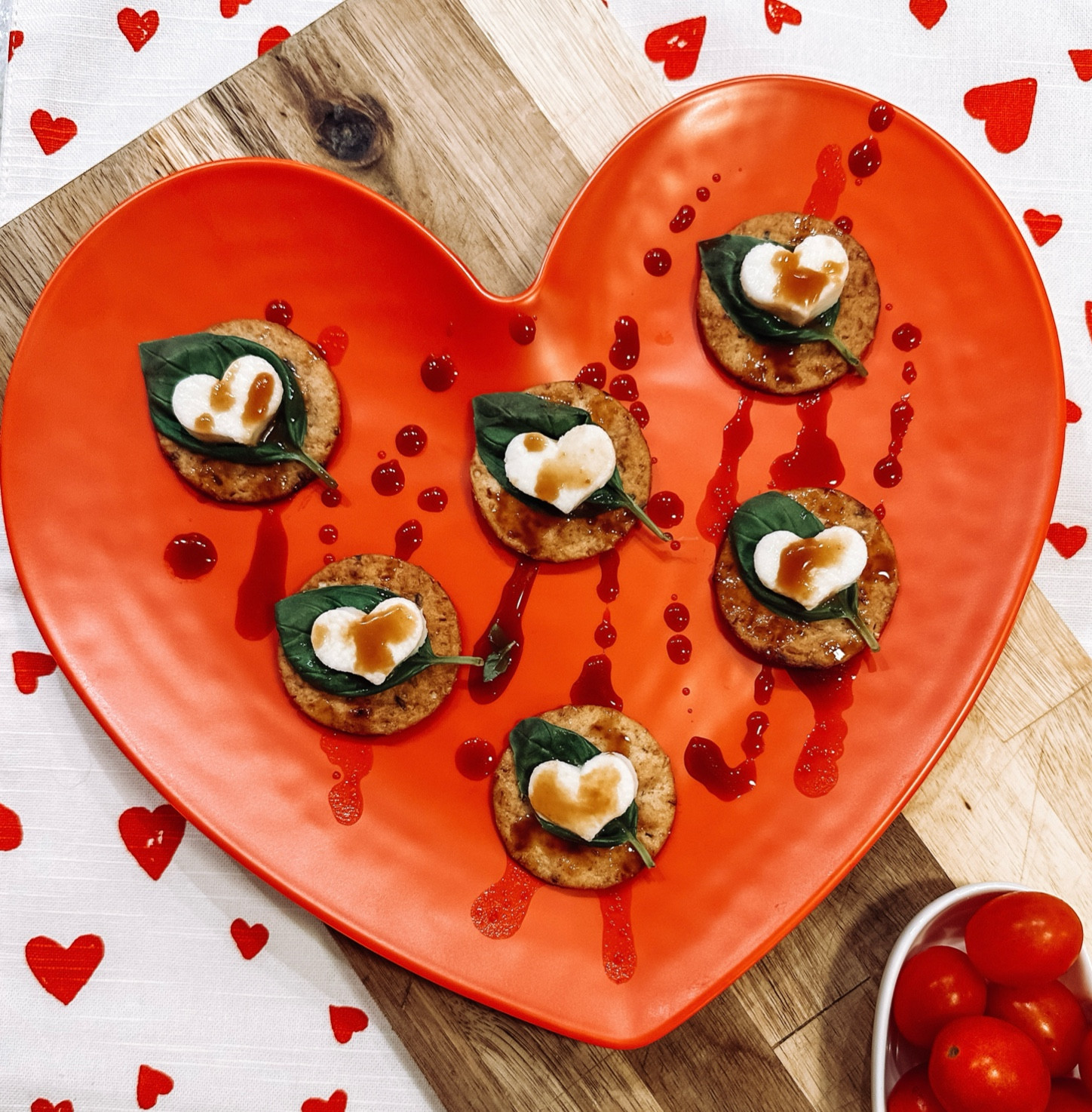 The tastiest appetizer! Perfect for date night or family night! All you need; crackers, mozzarella, heart cookie cutter, fresh basil, and a balsamic glaze! Love this plate for display!!!

#LTKhome #LTKSeasonal