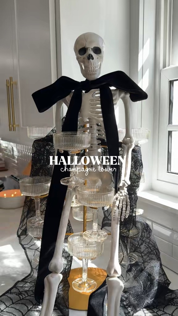 A DIY Halloween Champagne Tower you can put together in minutes for your holiday hosting this month 💀🎃✨🥂 + this skeleton has been my favorite Halloween decoration over the years!