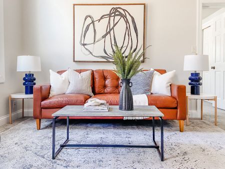Everything doesn’t have to match to coordinate in your space - try mixing table styles for a unique eclectic design !
.
.
.
Brown Leather Sofa
Tufted Faux Leather Sofa
Faux Concrete Coffee Table
White & Natural Wood End Table
Navy Blue Lamp
Eclectic Design 

#LTKhome #LTKbeauty #LTKstyletip