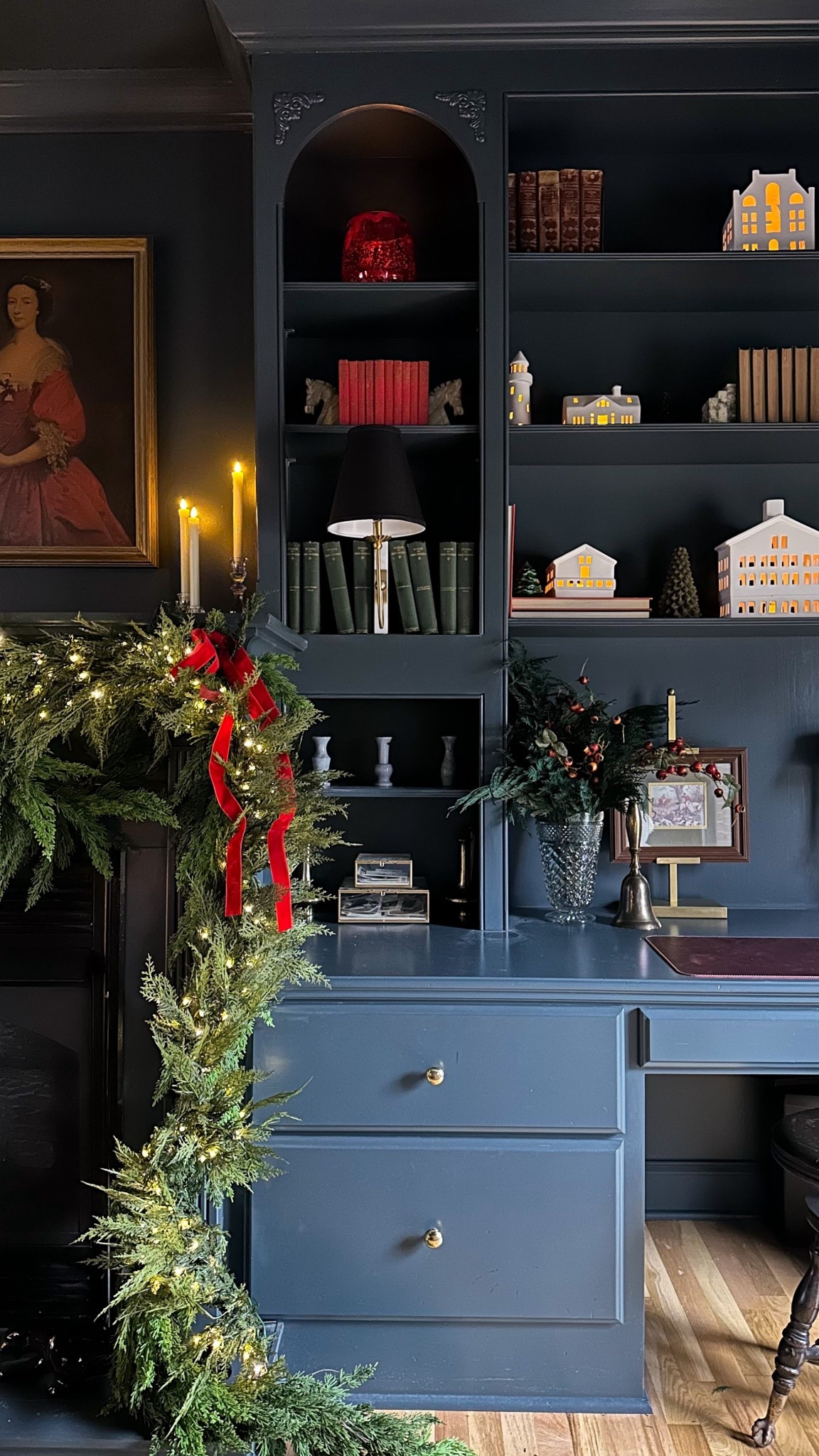 A glimpse of Christmas in my cozy tv room. Every year I change my decorations just a little. This year I layered cedar garland as a base and the prelit hemlock  garland on top. Some premade bright red bows flanking the corners gave it a little something extra and my white ceramic village on the bookshelves adds more glow. So happy with how the Christmas decor is shaping up this year 🎄

#LTKHome #LTKSeasonal #LTKHoliday