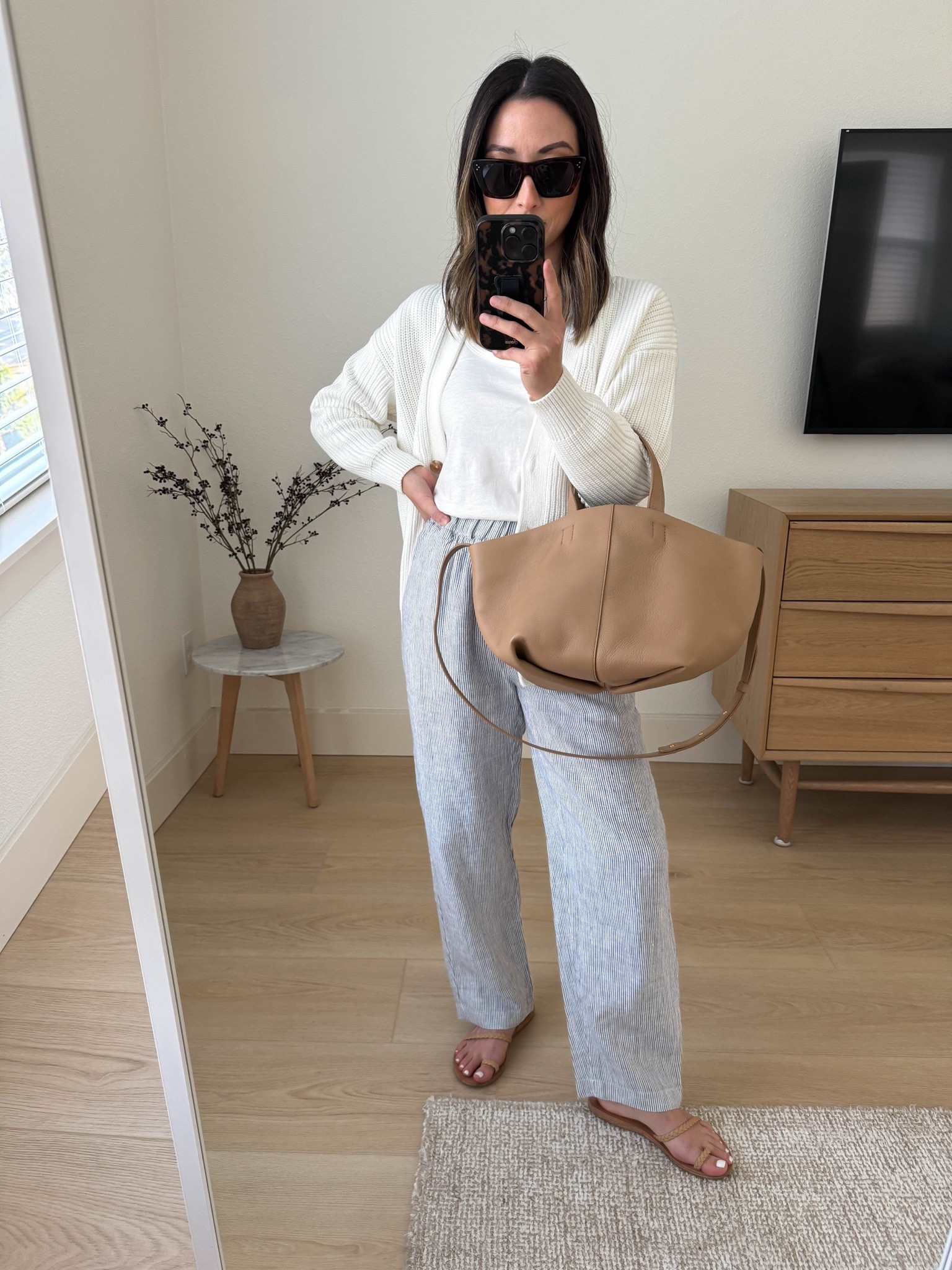 Quince 100% Organic Cotton Oversized Boyfriend Cardigan - Perfectly oversized for petites! Arms are the perfect length for us. The white is stunning! Runs tts.  Color is ivory

100% European Linen Pants - Was surprised by these! Ended up getting them in 4 colors. Length is petite-friendly. Elastic was, so comfy and casual. Wider in the thighs and then a slight taper at the ankle. 

Quince cardigan xs
Reformation tank xs
Quince pants xs
Ancient Greek sandals 35
Mansur Gavriel tote 
Celine sunglasses

Vacation outfit, spring outfit, petite style, sandals, purse 



#LTKitbag #LTKshoecrush #LTKfindsunder100