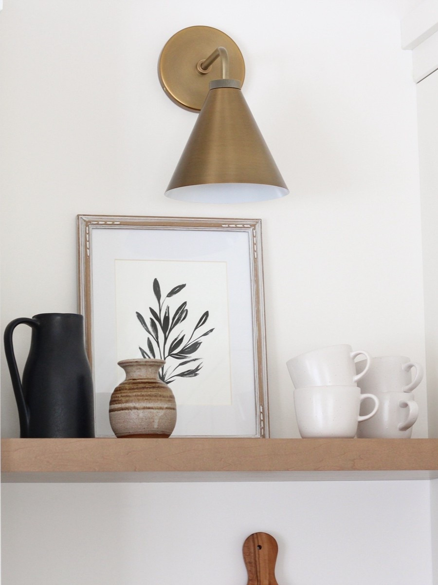 One of the best decisions we made in our kitchen was installing this brass sconce above the open shelves. No matter the time of day, it always looks great. Love the warmth and additional lighting!

#LTKSeasonal #LTKHome