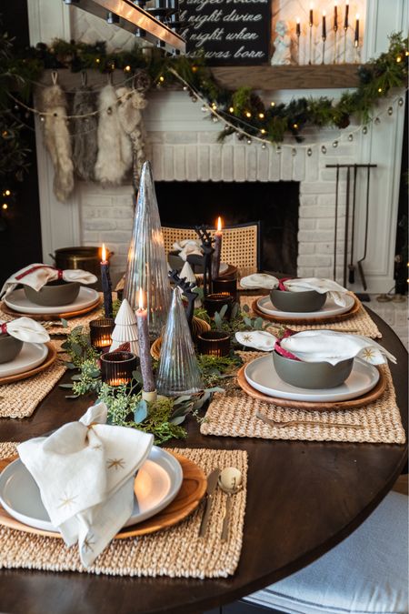 Christmas table setting with green bowls, glass Christmas trees, black reindeer, seasonal napkins with ribbon, and garland


#LTKSeasonal #LTKhome #LTKHoliday
