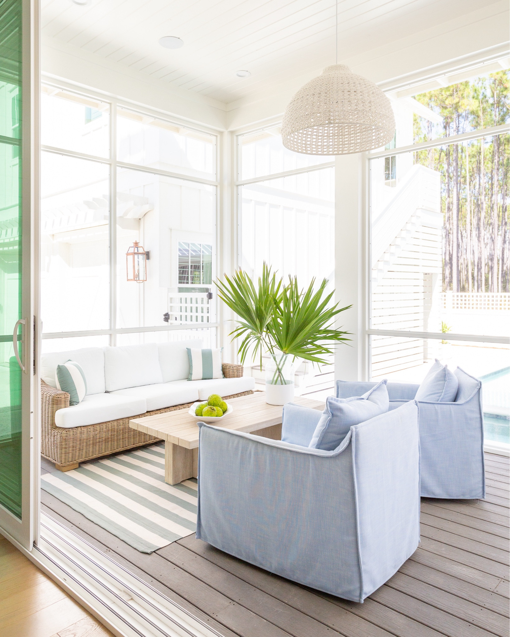  *Many of these items are currently on sale* A look at our outdoor living room in our screened in porch! We absolutely love this outdoor sofa, upholstered swivel chairs, wood coffee table, rope chandelier, striped outdoor rug and coastal accents! See our full new home tour here: https://lifeonvirginiastreet.com/a-peek-at-our-new-florida-home/.
.
#ltkhome #ltkseasonal #ltkstyletip #ltkfindsunder50 #ltkfindsunder100 #ltksalealert #ltkfamily outdoor living room, pool furniture, patio furniture, blue and white decor, coastal grandmillennial style

#LTKSeasonal #LTKHome #LTKSaleAlert