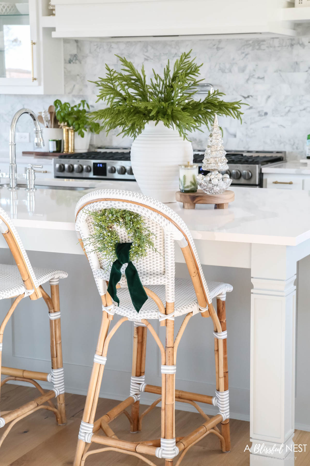 Simple wreaths on the stools made the whole kitchen feel festive and cozy. Grab the holiday accents here.
illuminated mercury Christmas trees, artificial Norfolk pine branches, suede velvet ribbon, faux juniper wreath, textured ribbed vase, Thymes Frasier Fir candle 

 #LTKHoliday #LTKSeasonal #LTKHome