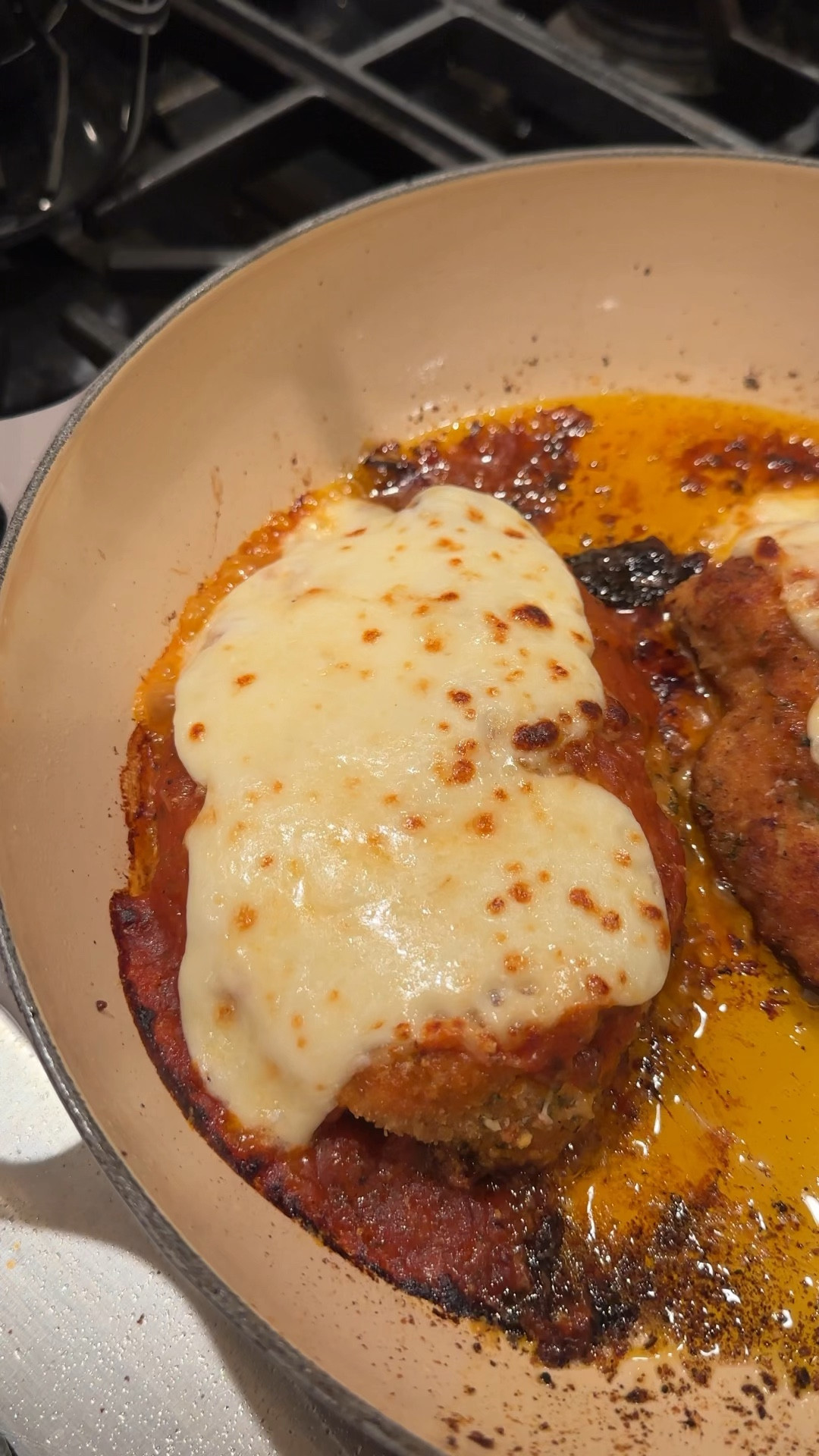 Chicken Parmesan

 Here's what you'll need:

1 jar of your favorite marinara sauce
2 chicken cutlets (recipe below)
1 package of fresh mozzarella cheese
1/2 cup of freshly grated parmesan cheese
1/2 lb of rigatoni
Handful of freshly chopped basil

Chicken Cutlets:
Thinly sliced chicken breast
1/3 cup half and half
1/2 cup panko bread crumbs
1/2 cup Italian bread crumbs
1/2 cup grated parmesan cheese
1 cup olive oil
4 tablespoons butter
Salt and Pepper
Granulated garlic
Italian seasonings

To make the chicken cutlets:
Add half and half, salt, pepper, garlic powder, and seasonings to the chicken breasts.
Mix panko, breadcrumbs, cheese, and seasonings in a separate bowl.
Press each side of the chicken into the breadcrumb mixture.
Heat up a pan with olive oil and butter.
Add chicken, two at a time to the pan and fry until golden brown on each side, flipping once.
Take out and drain on a plate with a paper towel.
Season with a sprinkle of salt, set aside.

Once all the chicken is cooked, add a ladle of marinara to the top of each one. Top with 2-3 pieces of fresh Mozzarella.
Bake at 350° for 15 minutes or until cheese has melted.
Remove, top with fresh Parmesan and broil to brown for 1-2 minutes.
Serve on top of pasta with marinara and freshly chopped basil and enjoy!

#LTKfamily #LTKhome #LTKVideo