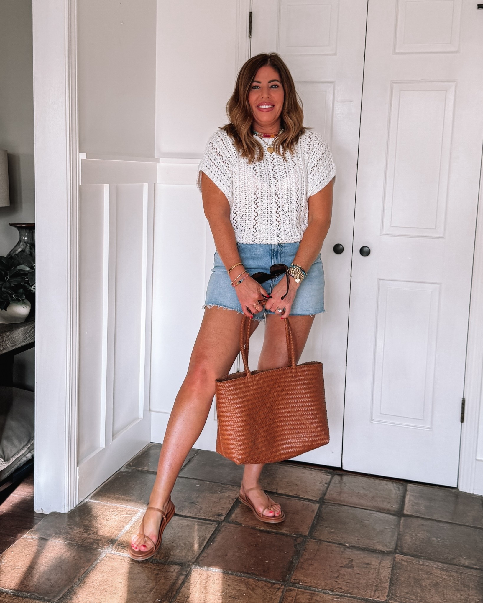 Perfect elevated casual summer outfit!

I plan on taking both of these pieces with me on vacation. These shorts are technically a mid rise, but they fit me more like a high-rise. They have the perfect amount of stretch and the perfect length they’re flattering and very comfortable. I’m wearing a 29.

This crochet sweater is so precious! As soon as I saw it, I had to have it. I love the texture and the fit. I love that you can dress it up or down. I’m wearing a medium.

My new beautiful woven leather Madewell tote. This bag is not only amazing quality, but it’s the perfect everyday size especially for us moms. I like to take it with me when I travel too!

The sandals are so comfortable and I love the minimal design. They are true to size.



#LTKootd #LTKTravel #LTKOver40