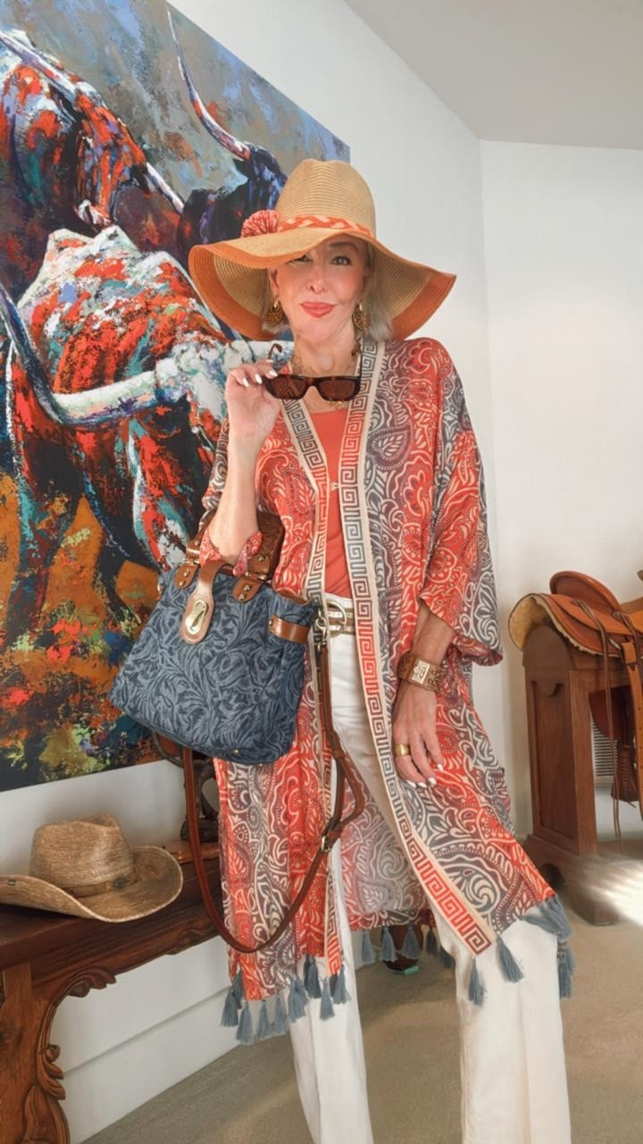 Ruana coverup or duster over
Off white flare jeans
Denim and tooled leather bag
Tortoise sunglasses 

#LTKTravel #LTKOver40 #LTKStyleTip