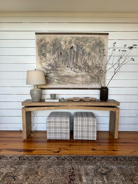 Console styling with this large rustic wood console and forest tapestry. We finished it off with a lamp, large vase with foraged stems, a book, and a candle. 

#LTKhome