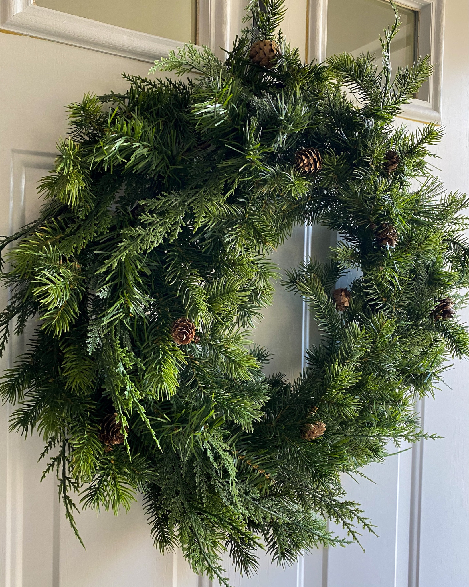 This mixed green wreath is back this year and still under $20! It’s a mix of real touch and traditional faux Christmas tree with bits of cypress mixed in and it’s just lovely! And don’t worry, it fluffs to look WAY more full than the online picture has it. And the pinecones are easily removed 

Christmas wreath. Holiday wreath. Christmas decorations. Budget friendly Christmas decor. Cedar wreath. Traditional wreath  

#LTKHoliday #LTKhome #LTKSeasonal