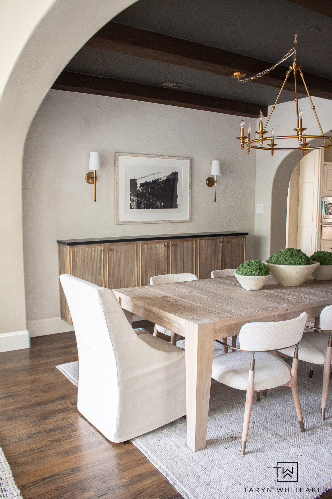 Neutral dining spaces will always have my heart. Clean lines, warm wood tones, and soft textures make this room feel elevated yet inviting—perfect for everyday meals and hosting. A timeless mix that works year-round and never feels overdone.

neutral dining room, modern organic style, warm wood dining table, upholstered dining chairs, brass chandelier, arched doorway, neutral home decor, timeless interiors

#LTKdayinmylife #LTKHome #LTKSeasonal
