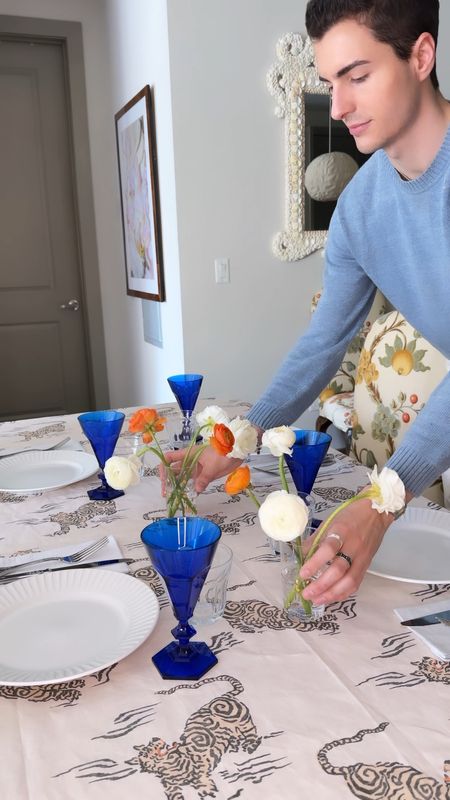 A simple spring table setting featuring my new tablecloth (over 80 options), blue acrylic goblet glasses, hotel style vintage silverware, and ranunculus blooms 

#LTKSeasonal #LTKstyletip #LTKhome