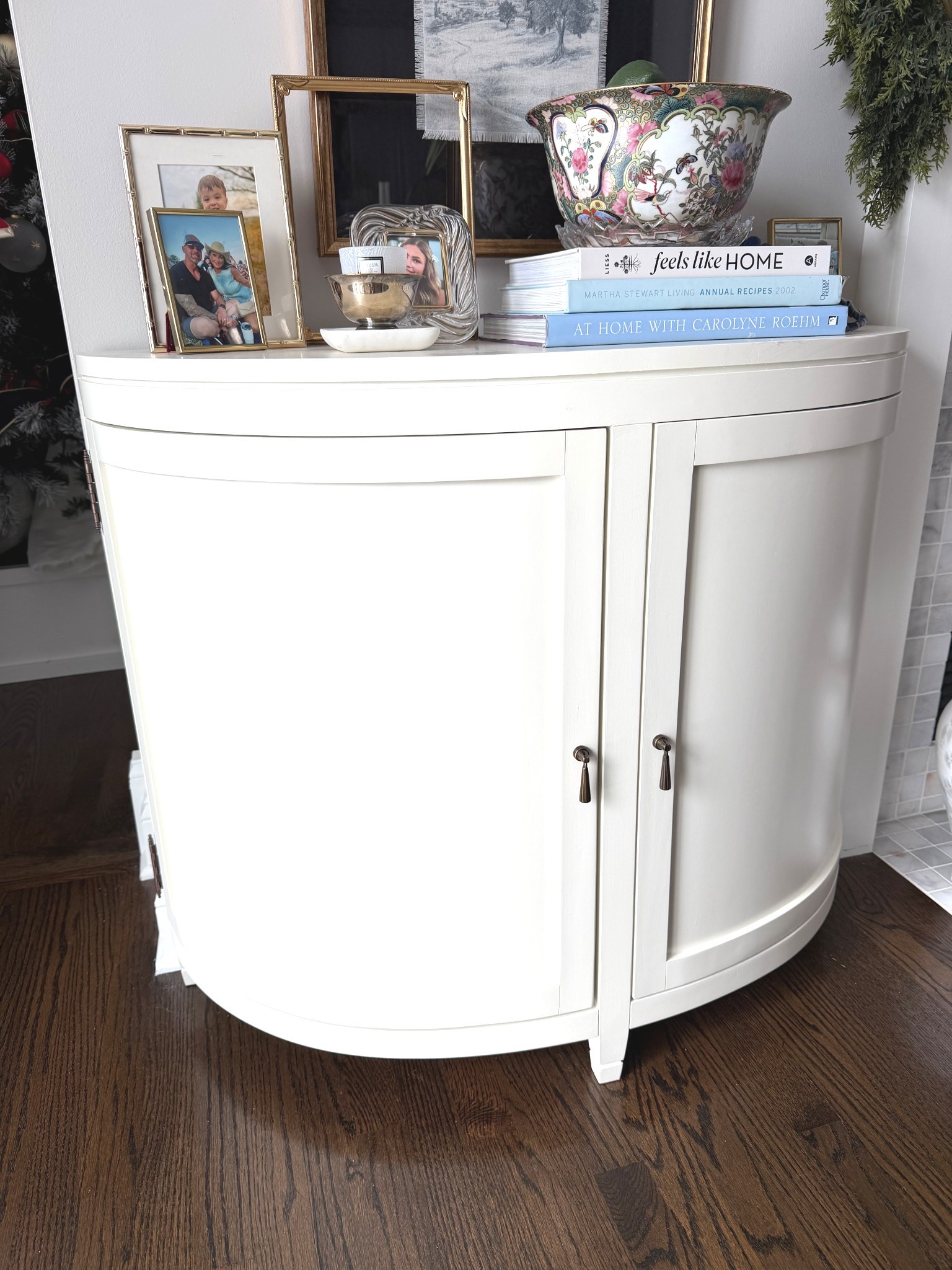 This is the Wynn Cabinet from Ballard Designs, and it’s one of my favorite pieces in my home. The curved shape, clean lines, and soft white finish make it so easy to style. I topped it with a stack of classic coffee table books, a few personal frames, and a vintage bowl for a curated, collected look. It adds just enough charm without feeling cluttered — the perfect mix of functional storage and beautiful styling.

I linked the cabinet along with some of the books and similar decor pieces so you can recreate the look.

#LTKHome #LTKdayinmylife
