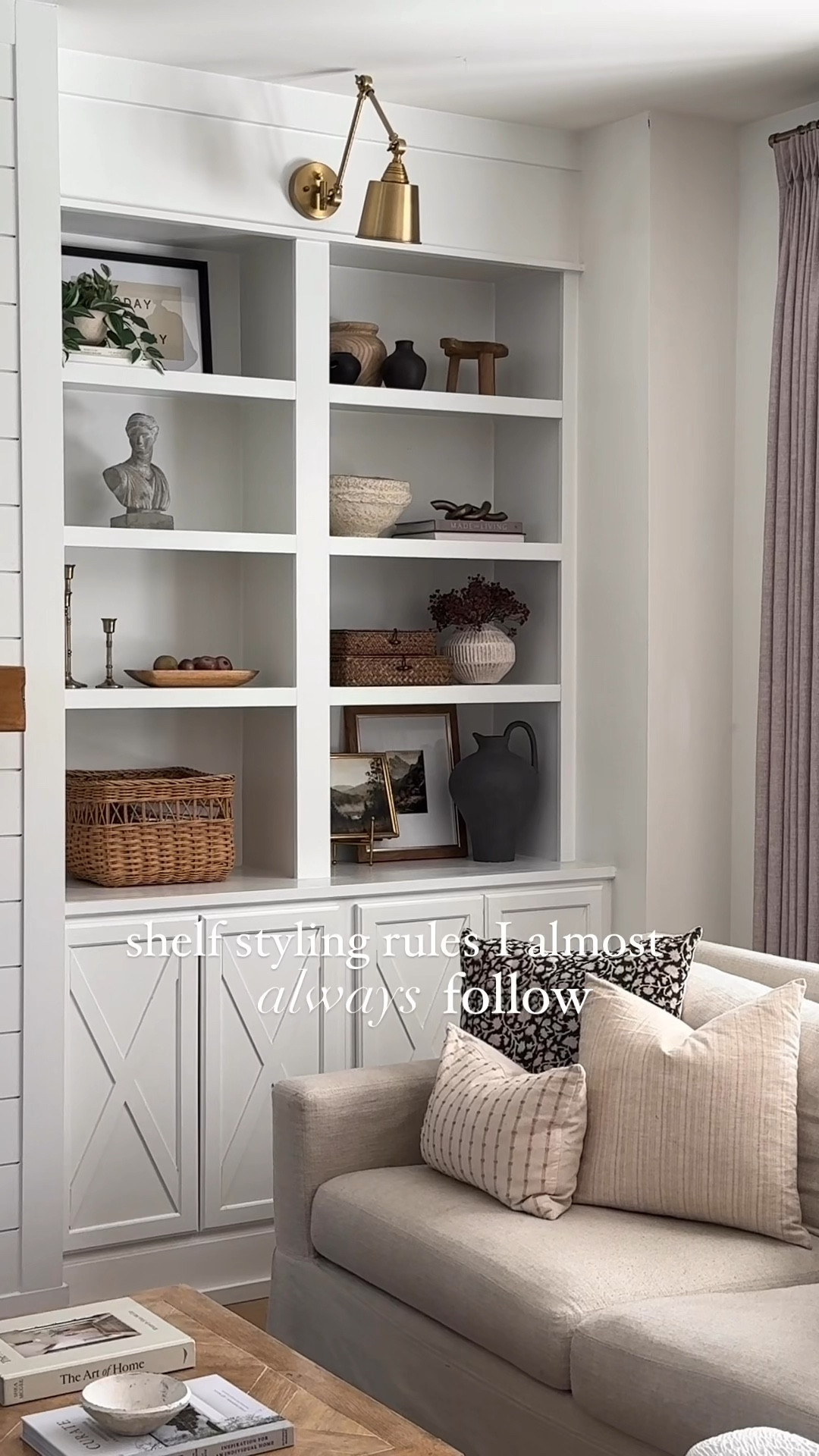 Shelf styling rules I almost always follow ⬇️

1. Repeat in diagonals: this applies to a lot of different items like picture frames, finishes like gold or brass, books, and even plants/stems. I tend to repeat, but I don’t love when those items are stacked directly on top of each other so I try to put these items in diagonals. I find that this creates interest and keeps things looking balanced. 

2. Layer: I tend to do this the most with my art. Instead of just having a picture frame in a shelf by itself. Layer it with a book stack and a plant, or find a smaller framer that fits in front of it. You can even put it on a easel like I did if the frame is on the smaller side. 

Add greenery: it doesn’t matter what season it is, I almost always have some sort of greenery in my shelves. I find that it adds texture and life (regardless of whether it is actually alive or not) 

And last but not least, less is more. You don’t want your shelves to feel cluttered, so make sure to leave some white space. 

#LTKStyleTip #LTKVideo #LTKHome